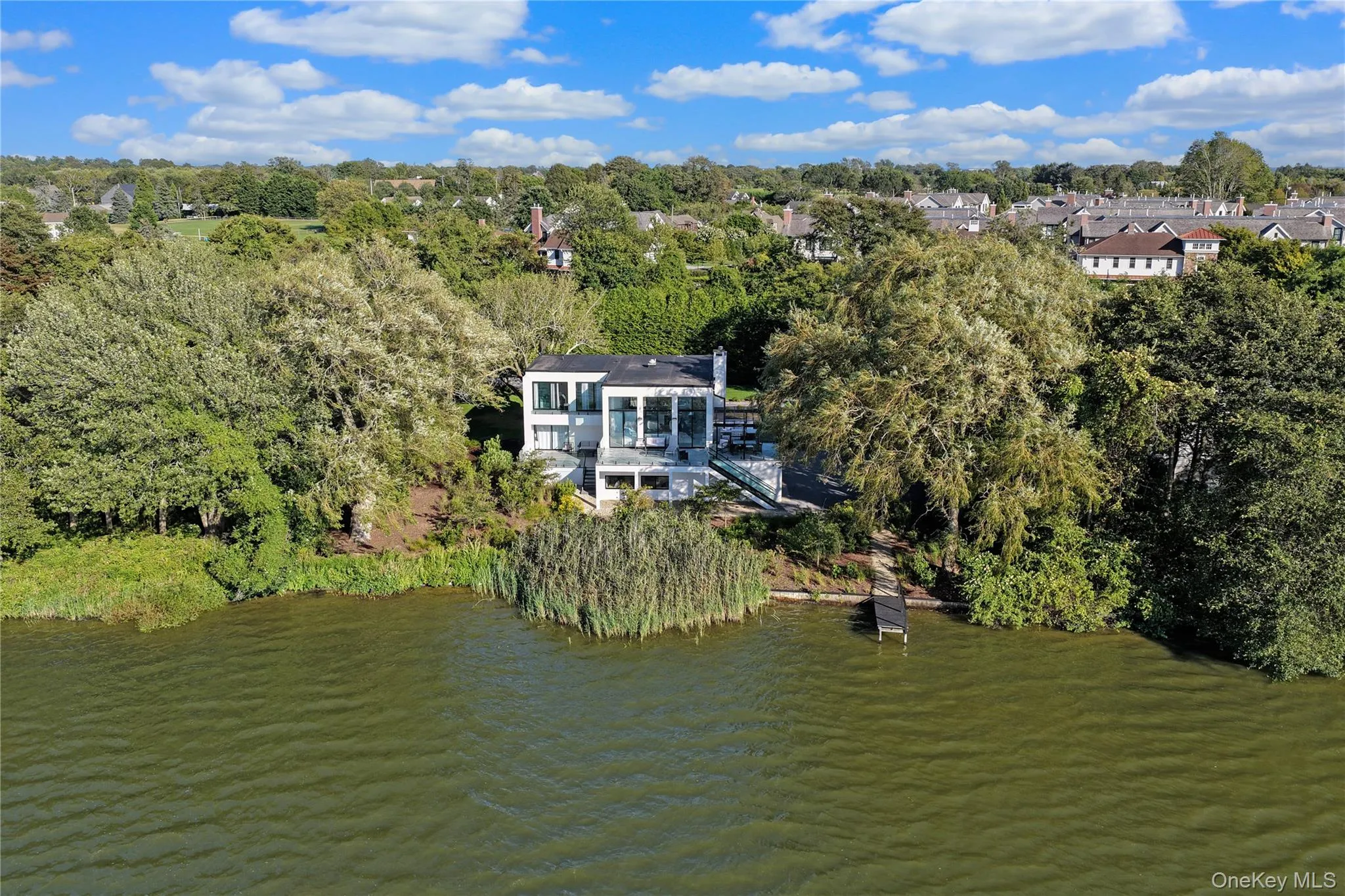 Aerial overview of property's location featuring a nearby body of water and a tree filled landscape Aerial overview of property's location featuring a nearby body of water and a tree filled landscape