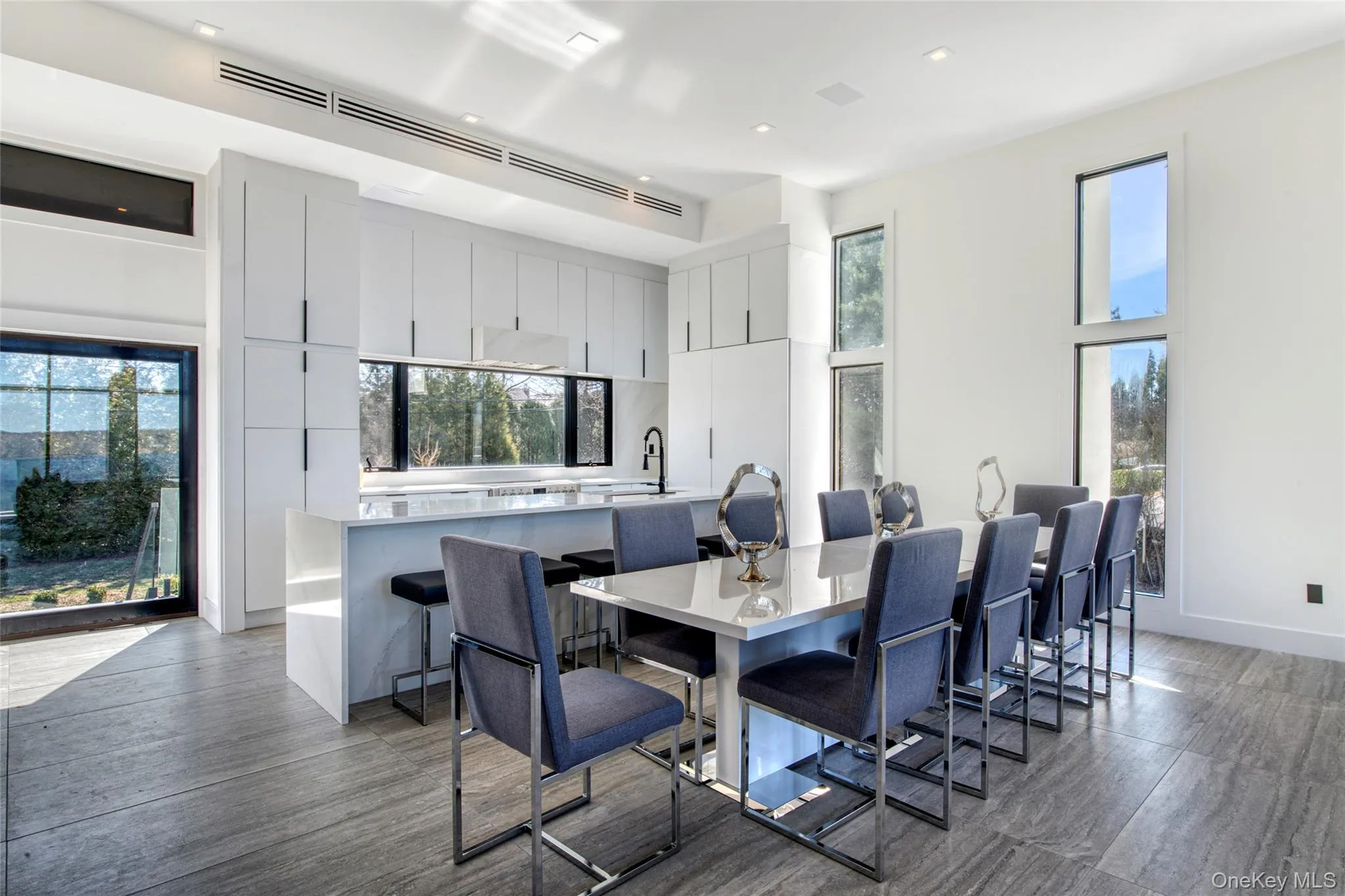 Dining space with baseboards, dark wood-style flooring, and a towering ceiling Dining space with baseboards, dark wood-style flooring, and a towering ceiling