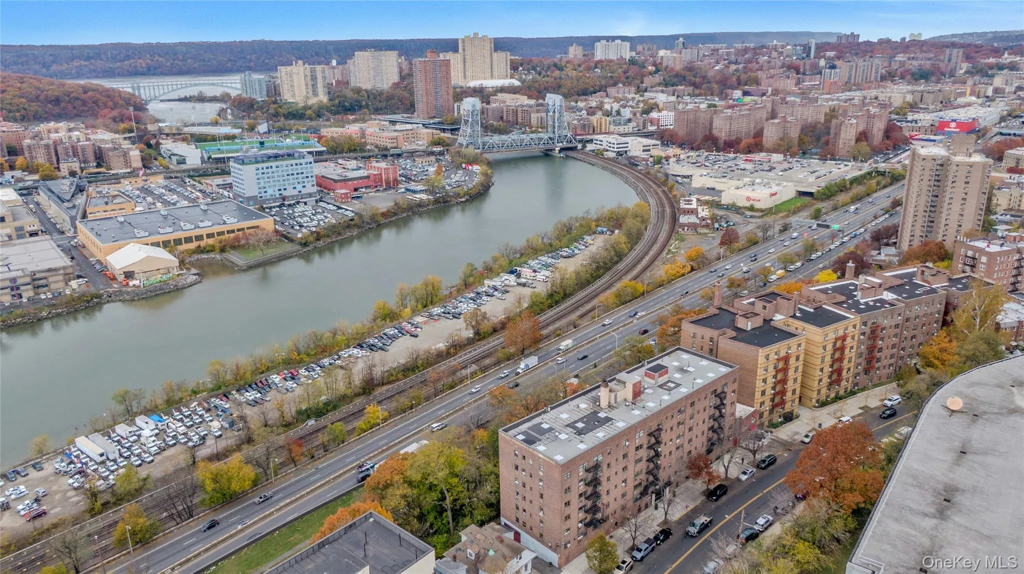 View of urban area featuring a notable bridge and a large body of water View of urban area featuring a notable bridge and a large body of water