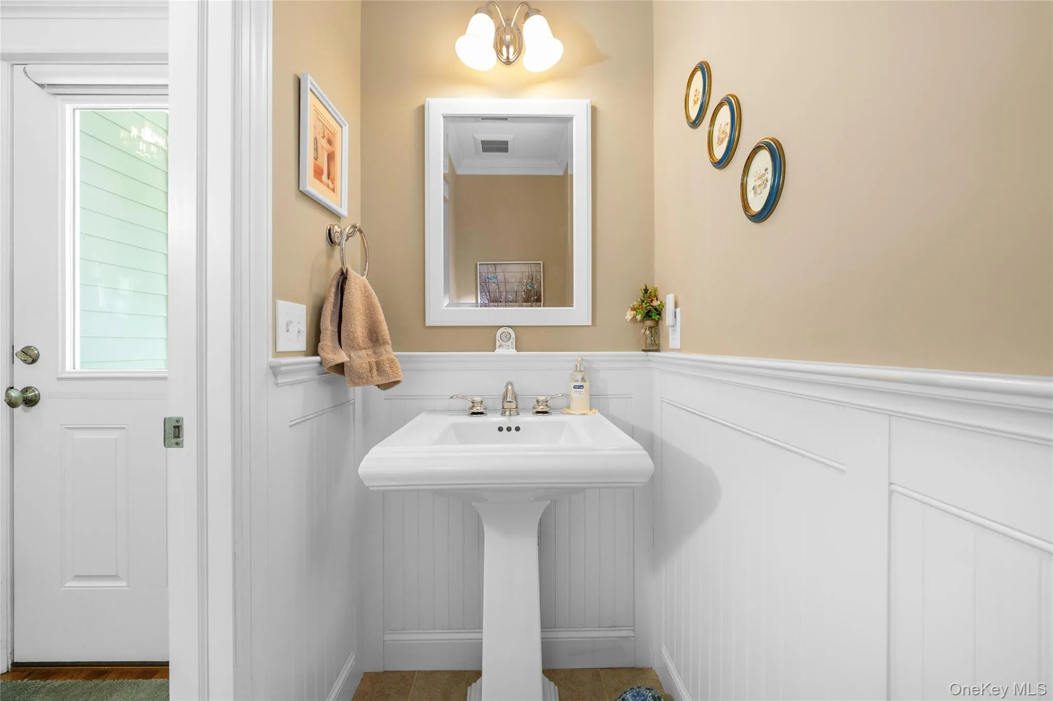 Bathroom with wainscoting and hanging lights Bathroom with wainscoting and hanging lights