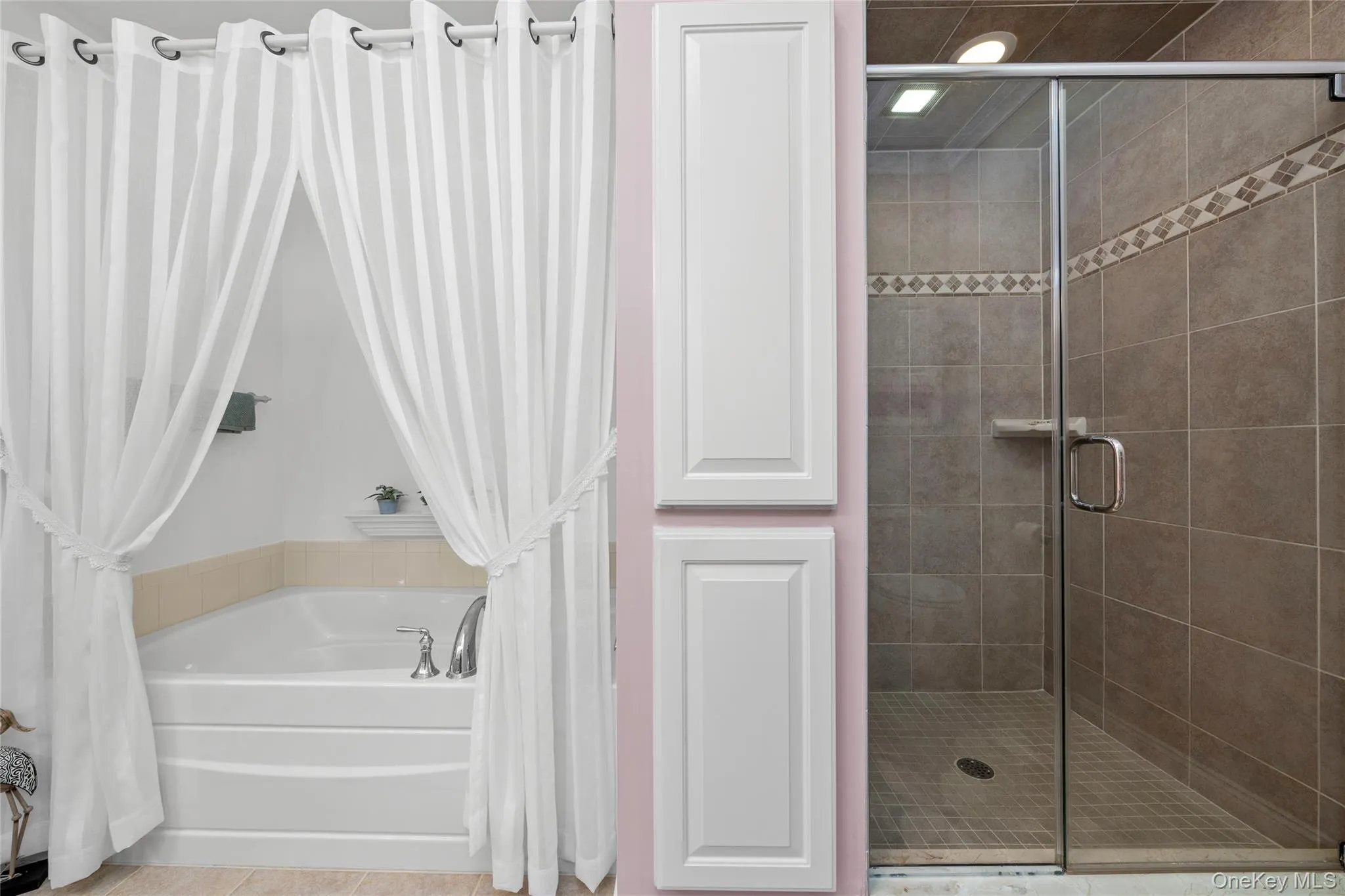 Full bathroom with a shower stall and a garden tub Full bathroom with a shower stall and a garden tub