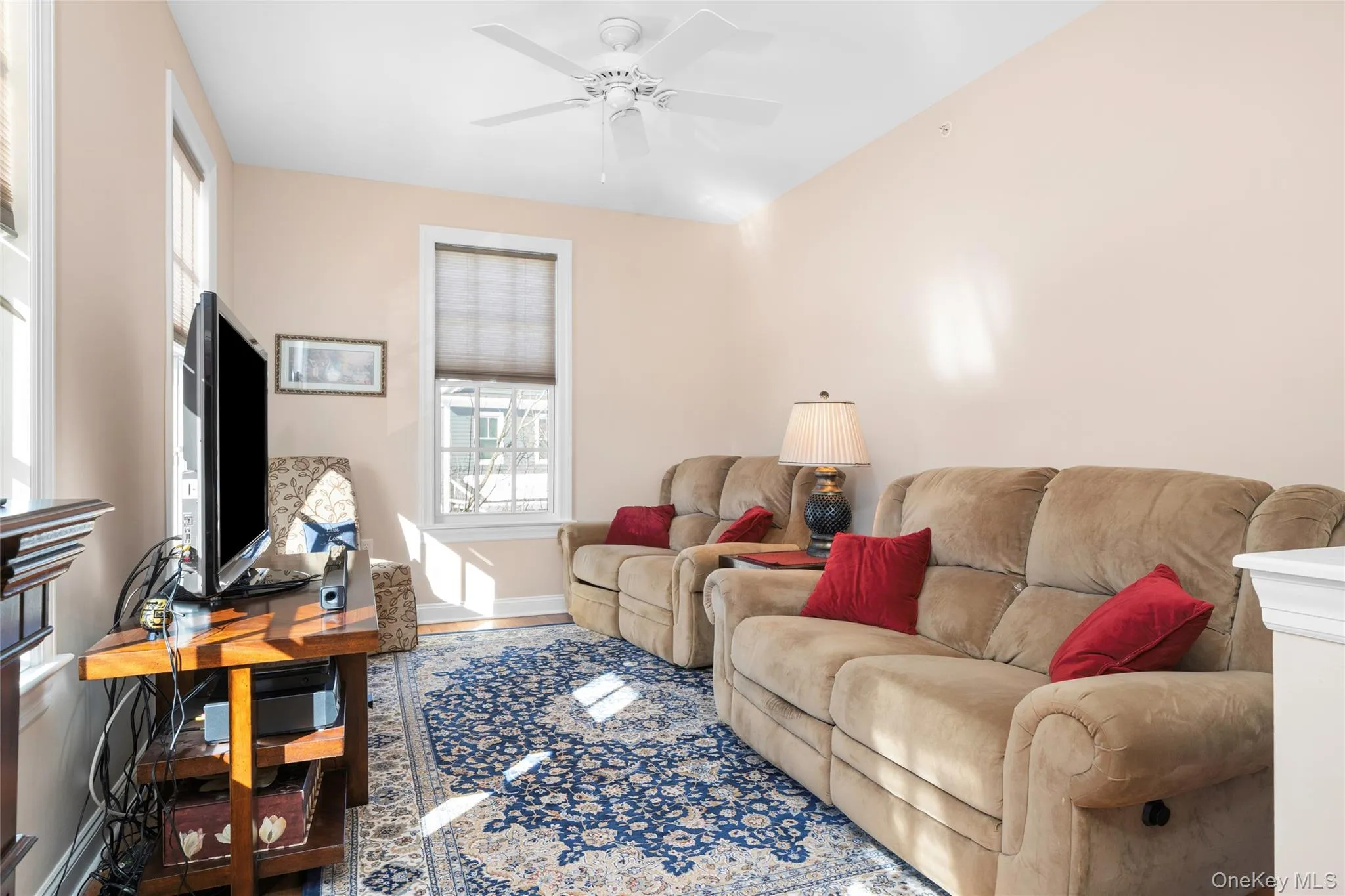 Sitting Area featuring a ceiling fan and wood-finished floors. Sitting Area featuring a ceiling fan and wood-finished floors.