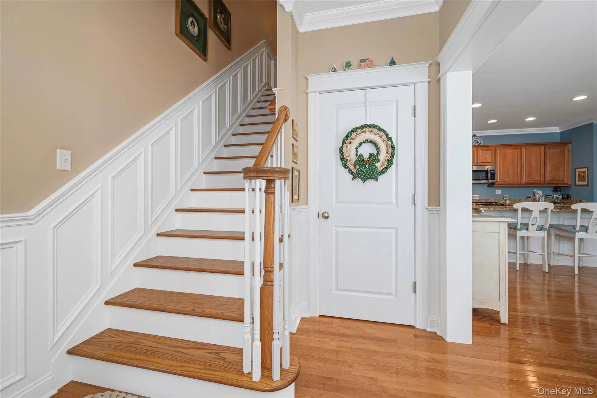Entrance foyer featuring ornamental molding, light wood finished floors, recessed lighting, and wainscoting Entrance foyer featuring ornamental molding, light wood finished floors, recessed lighting, and wainscoting
