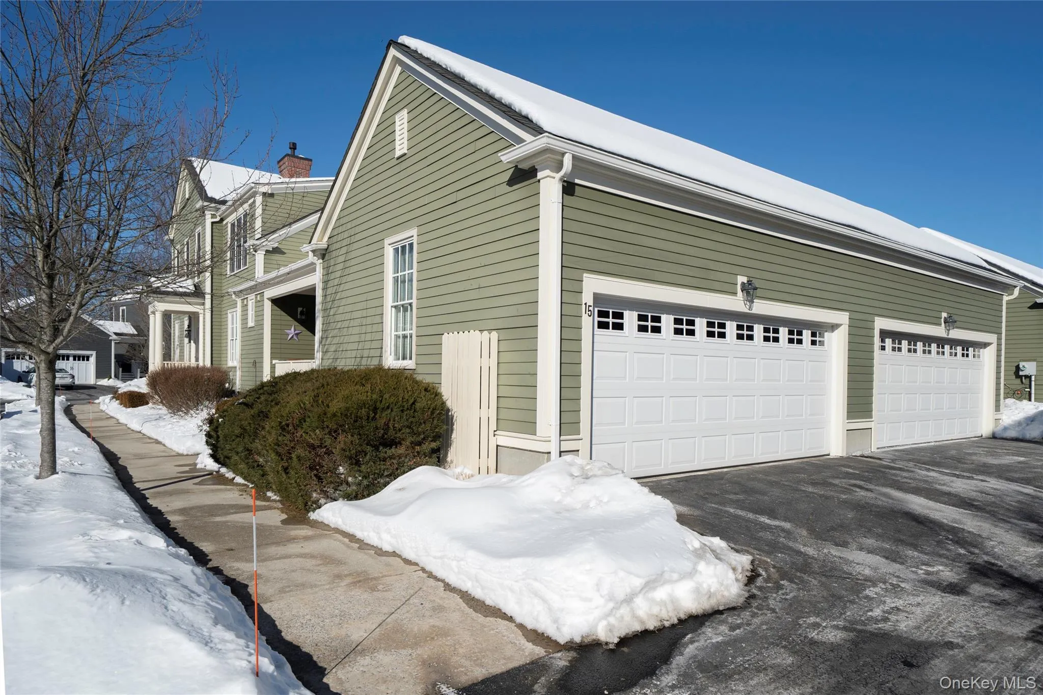 View of side of home with asphalt driveway and 2 car garage. View of side of home with asphalt driveway and 2 car garage.