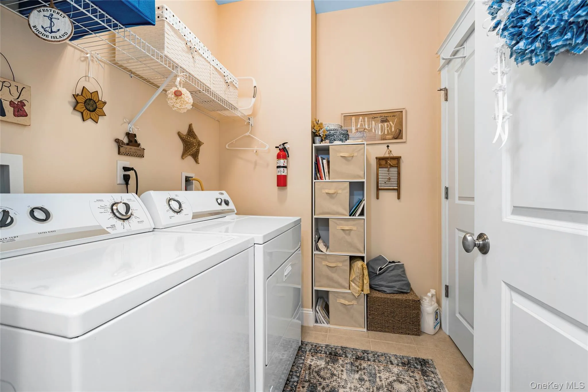 Laundry room featuring independent washer and dryer and tile patterned flooring Laundry room featuring independent washer and dryer and tile patterned flooring