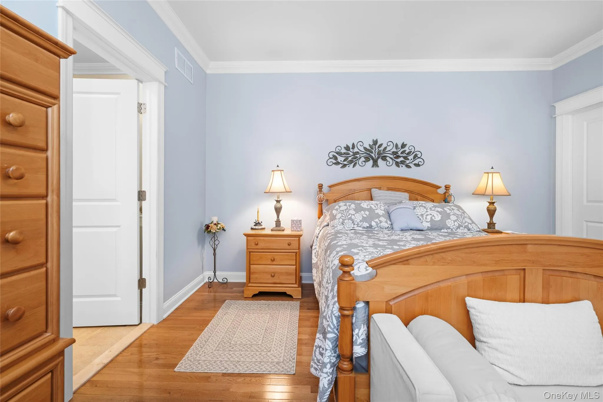 Bedroom with crown molding and hardwood / wood-style floors Bedroom with crown molding and hardwood / wood-style floors