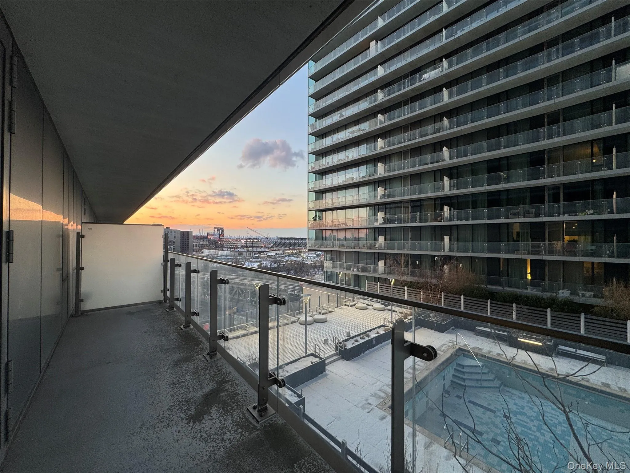 Balcony at dusk featuring a view of city Balcony at dusk featuring a view of city