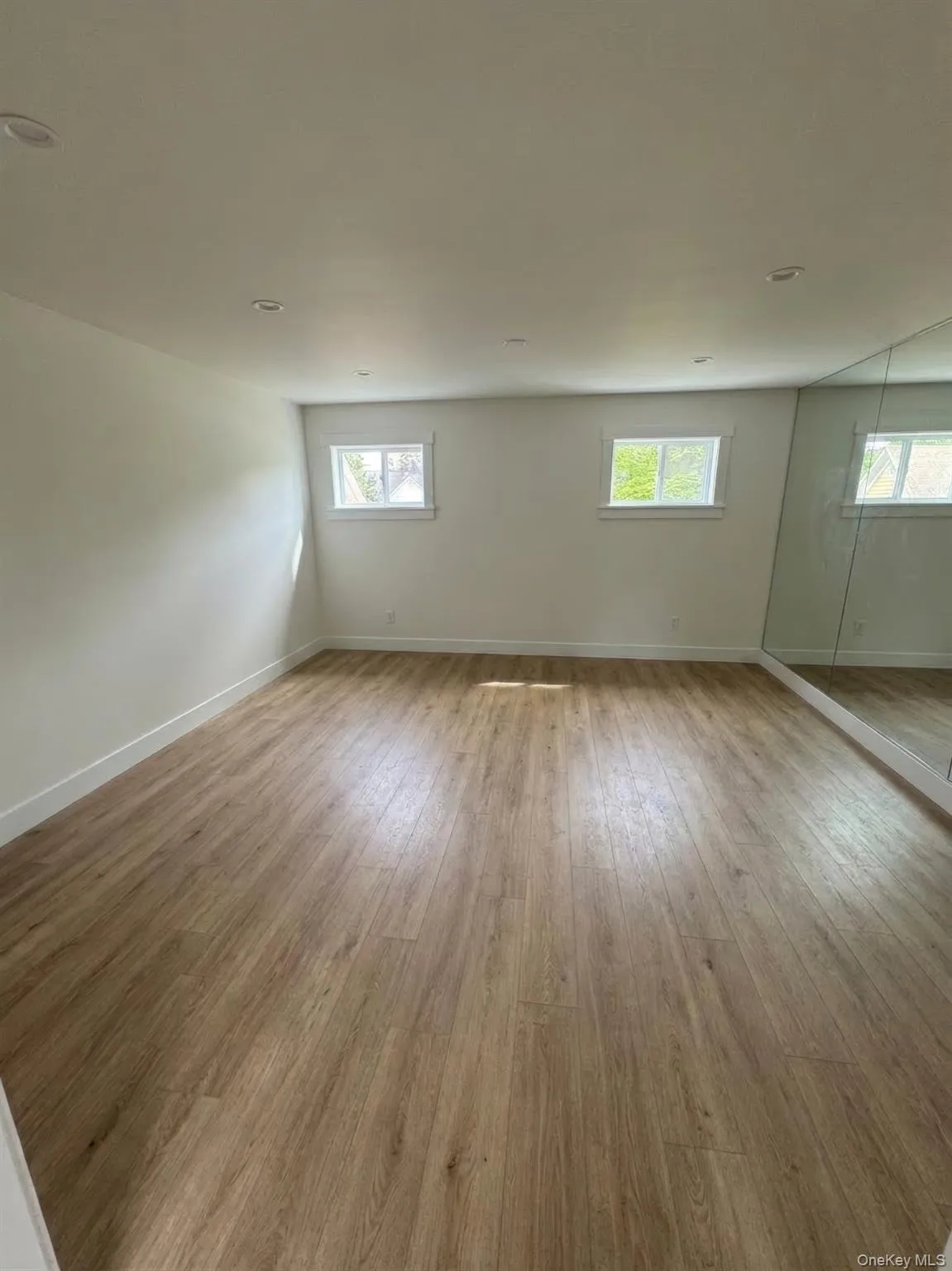 Spacious room featuring finish flooring and recessed ceiling lighting Spacious room featuring finish flooring and recessed ceiling lighting