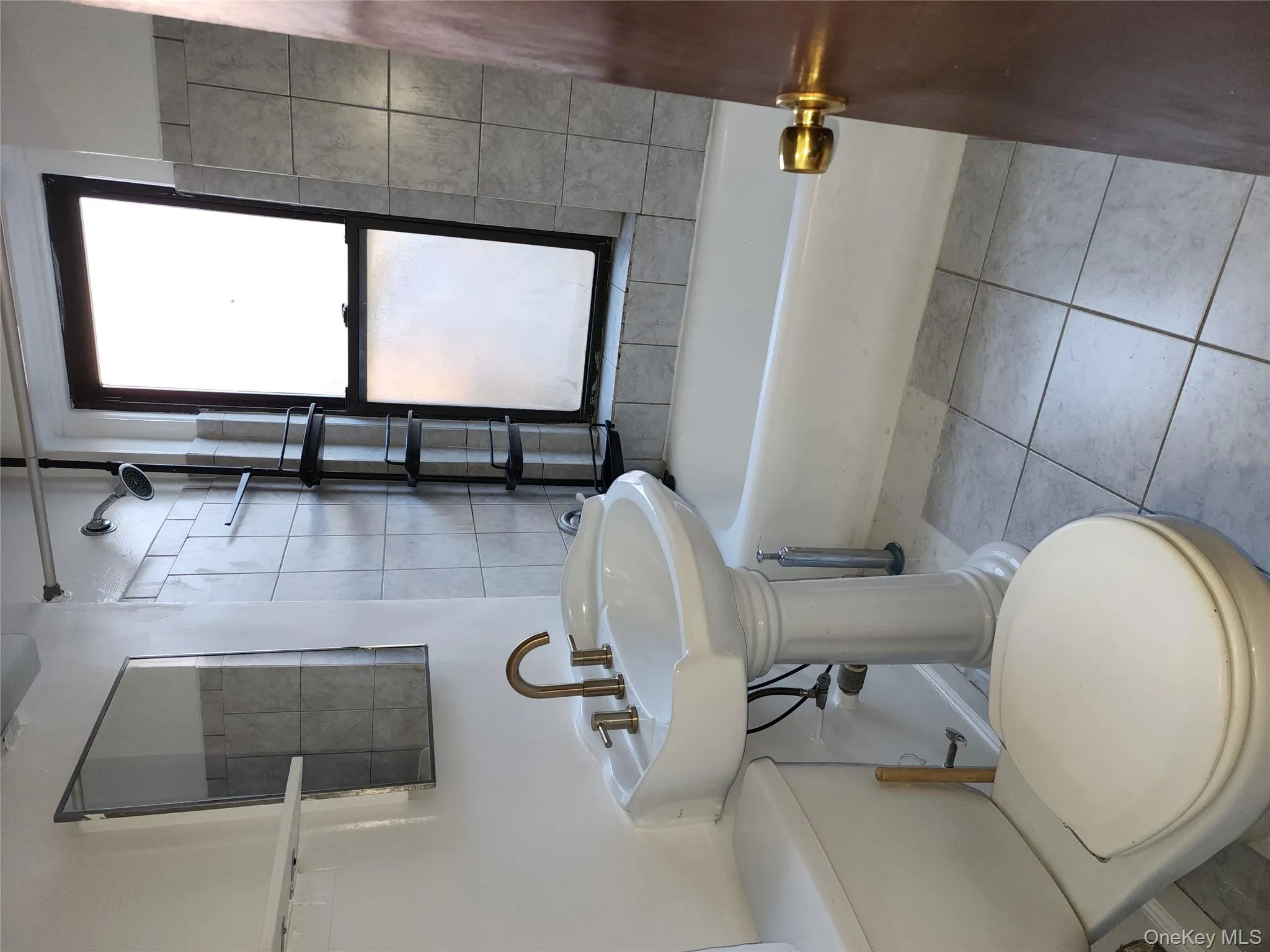 Bath with window , ceramic tiles, vanity, space saver by window. Bath with window , ceramic tiles, vanity, space saver by window.