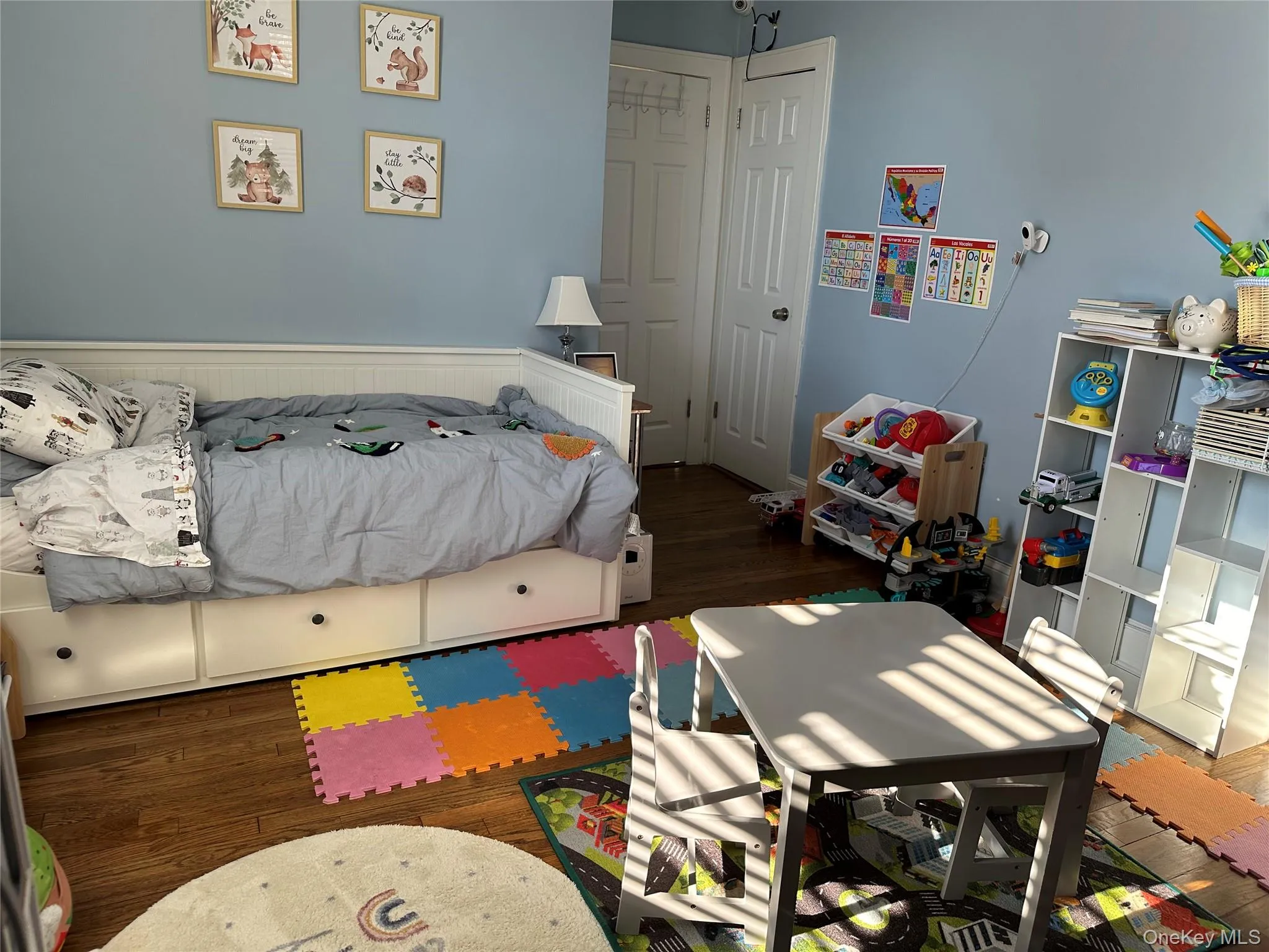 Bedroom with dark wood-type flooring and a closet Bedroom with dark wood-type flooring and a closet