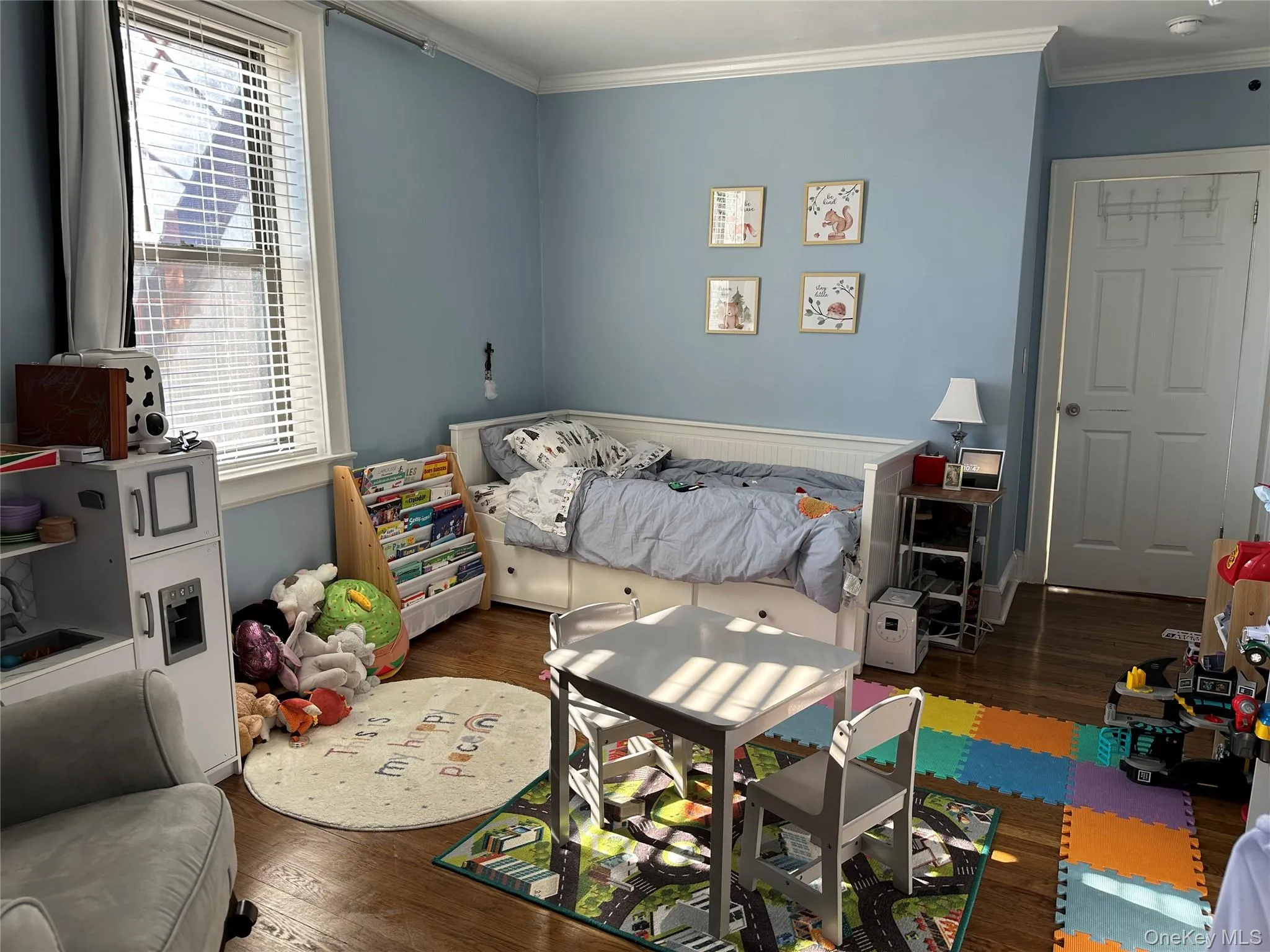 Bedroom featuring crown molding and dark wood-type flooring Bedroom featuring crown molding and dark wood-type flooring