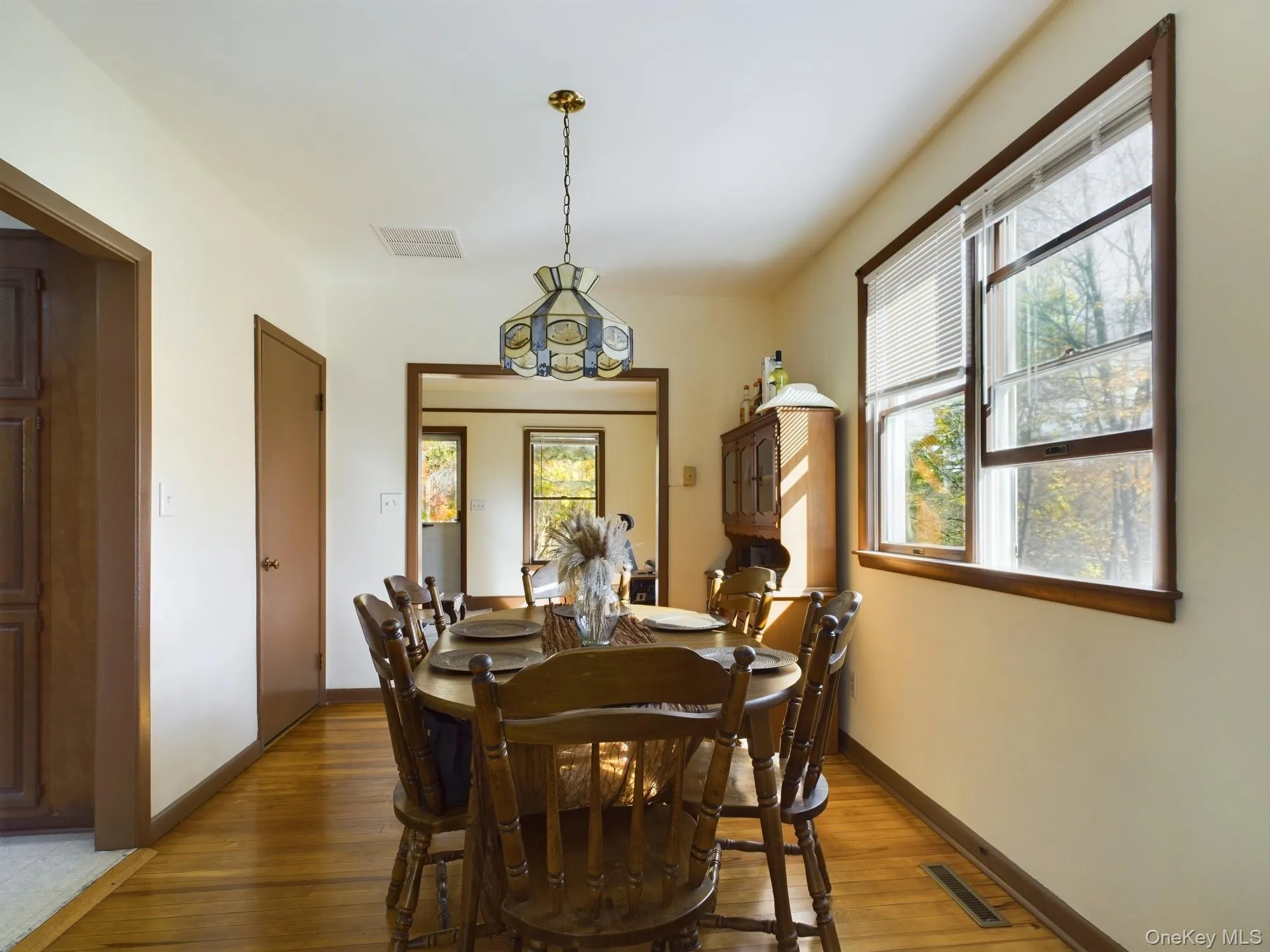 Dining space with wood finished floors and baseboards Dining space with wood finished floors and baseboards