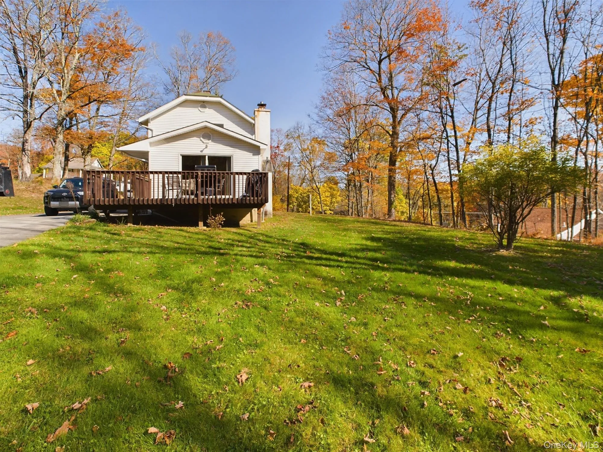View of green lawn with a deck View of green lawn with a deck