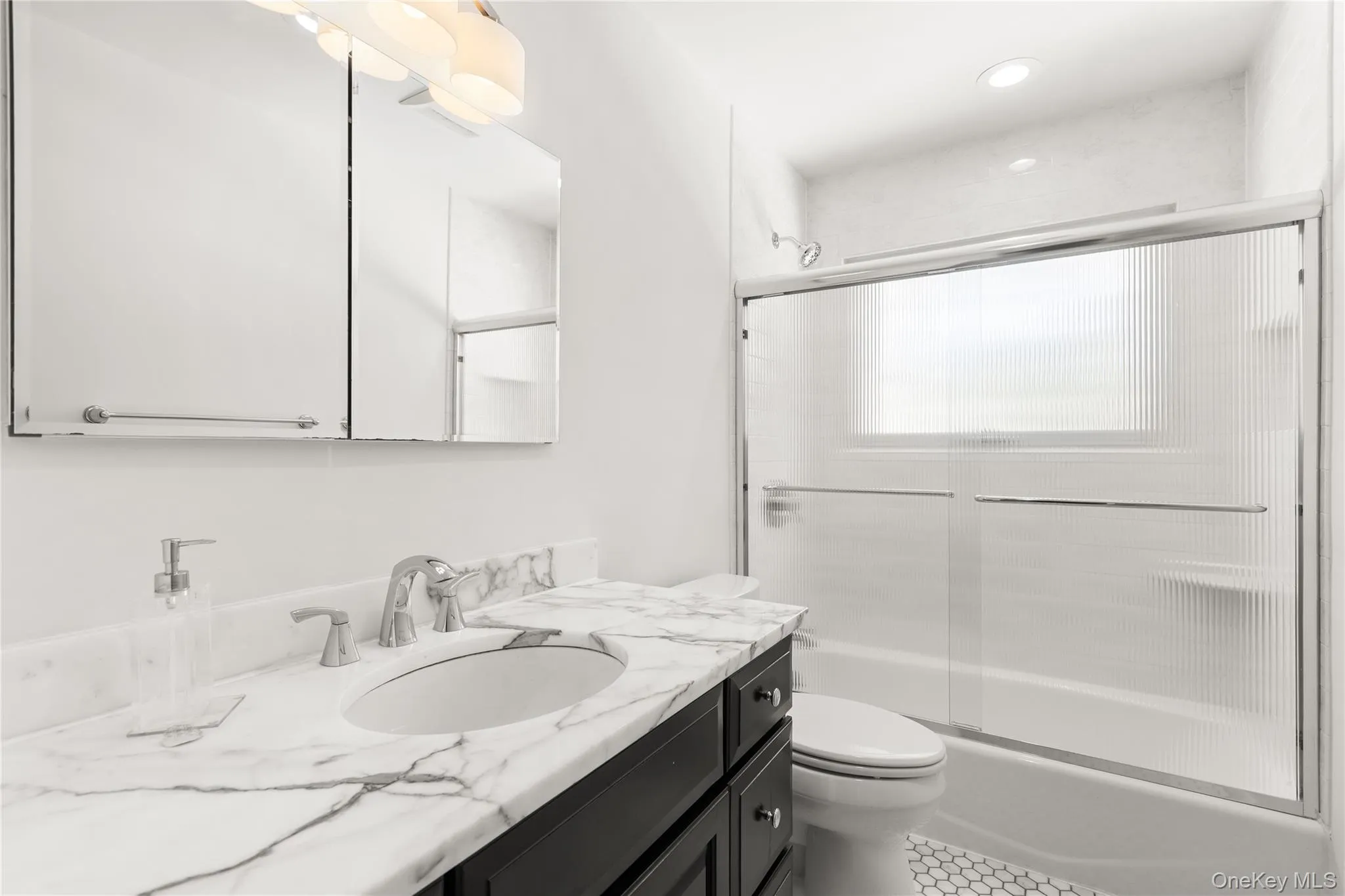 Full bath featuring vanity and bath / shower combo with glass door Full bath featuring vanity and bath / shower combo with glass door