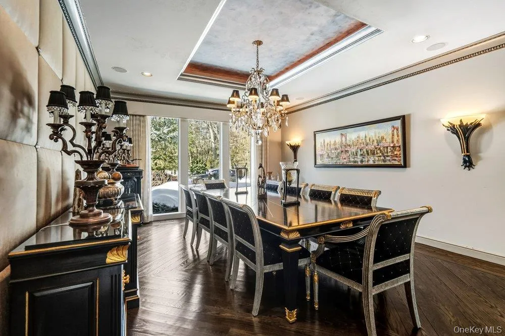 View of dining room with moldings, tray ceiling and hardwood floor View of dining room with moldings, tray ceiling and hardwood floor