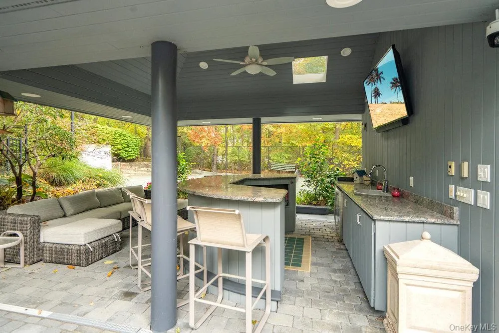 View of outdoor cabana seating between pool and tennis court View of outdoor cabana seating between pool and tennis court