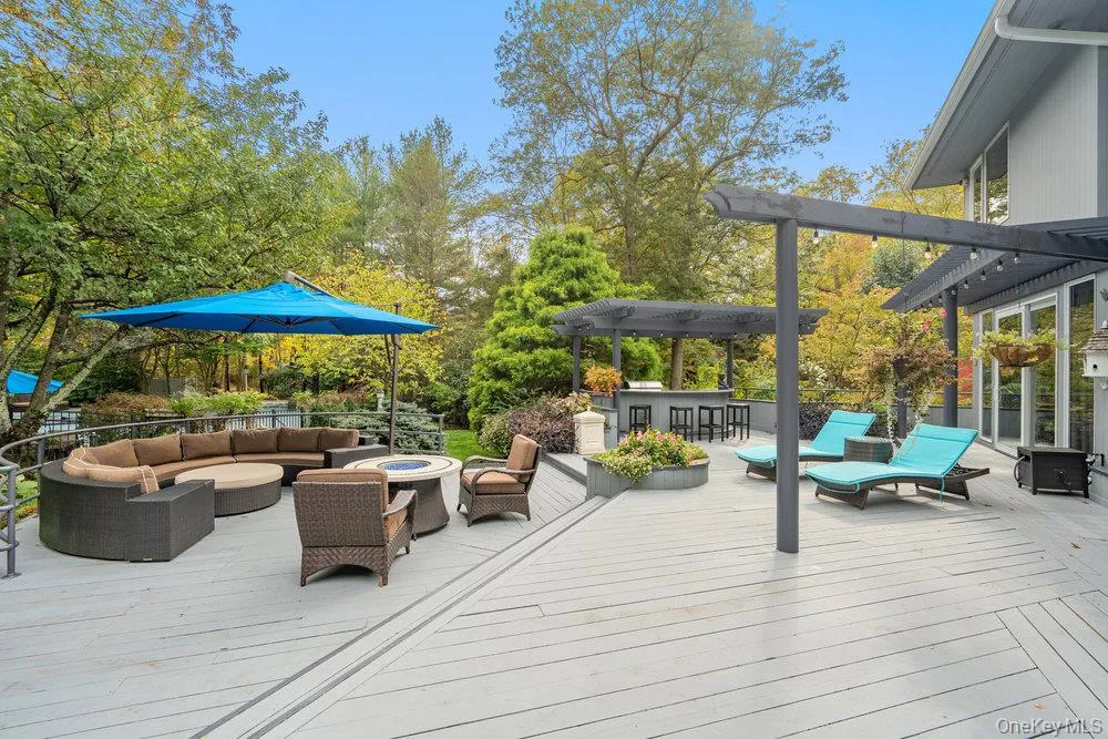 View of oversized wood deck with outdoor cooking and seating View of oversized wood deck with outdoor cooking and seating