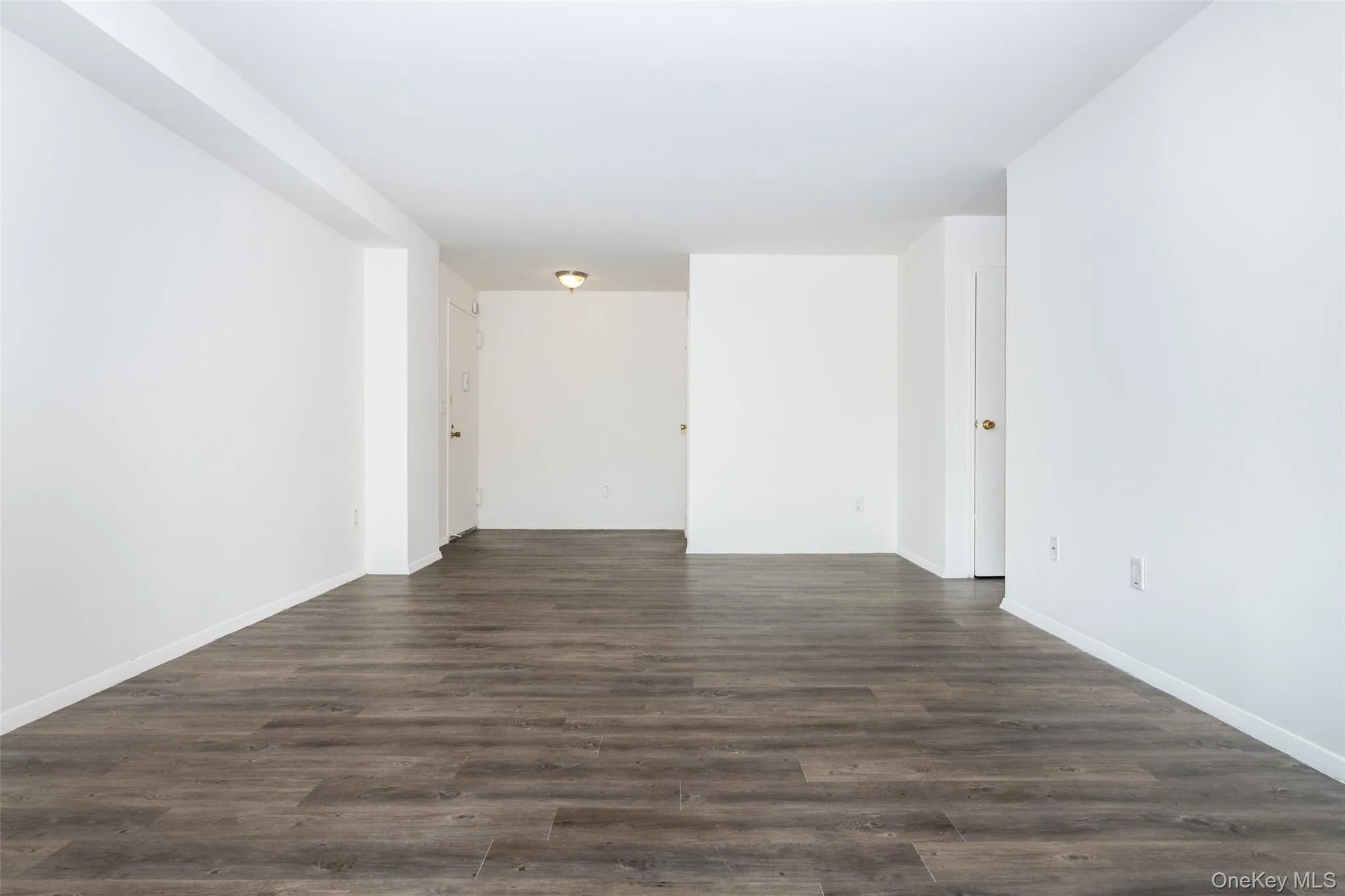 Empty room with dark wood finished floors Empty room with dark wood finished floors