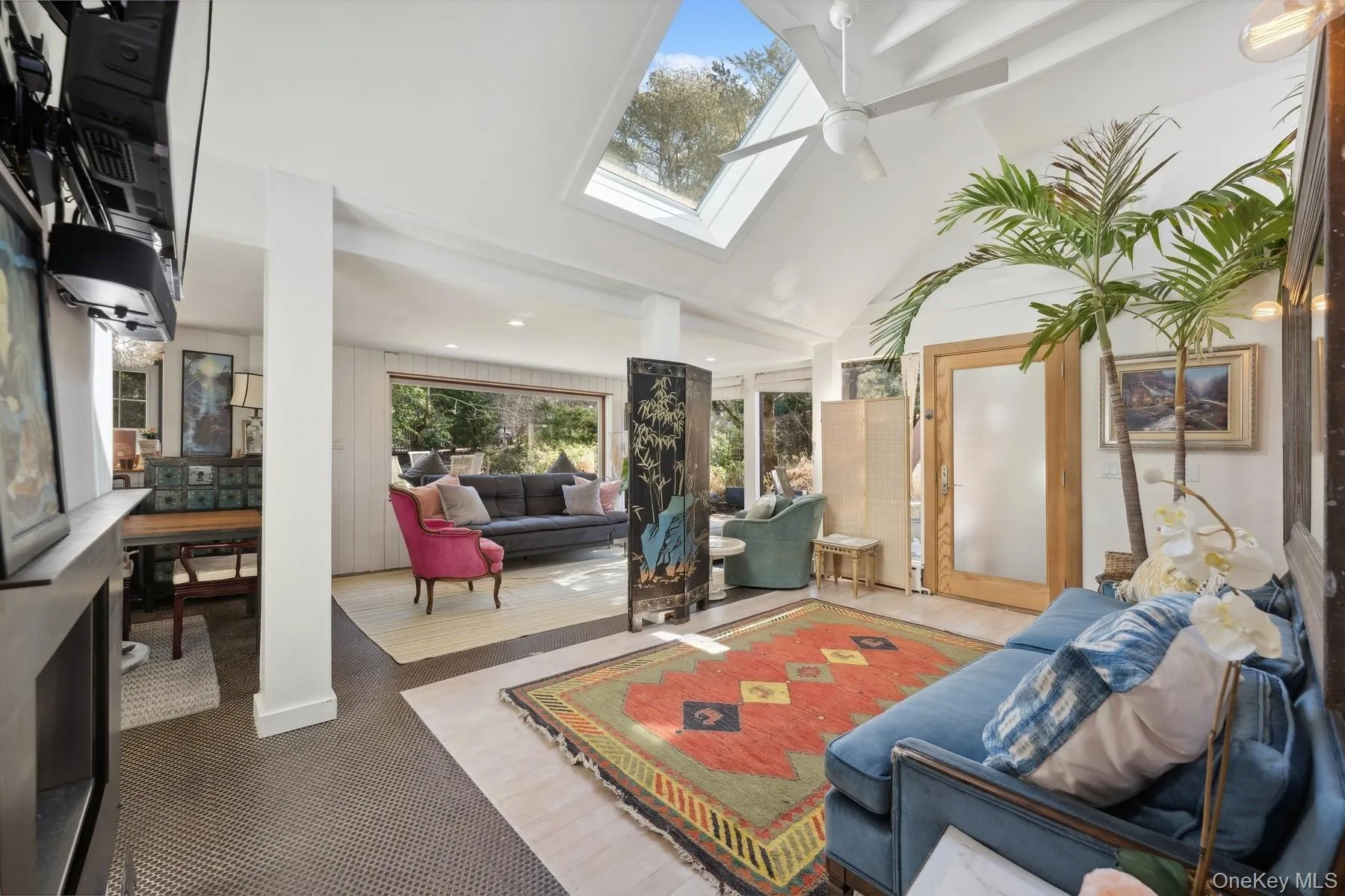 Sunroom featuring ceiling fan and lofted ceiling with skylight Sunroom featuring ceiling fan and lofted ceiling with skylight