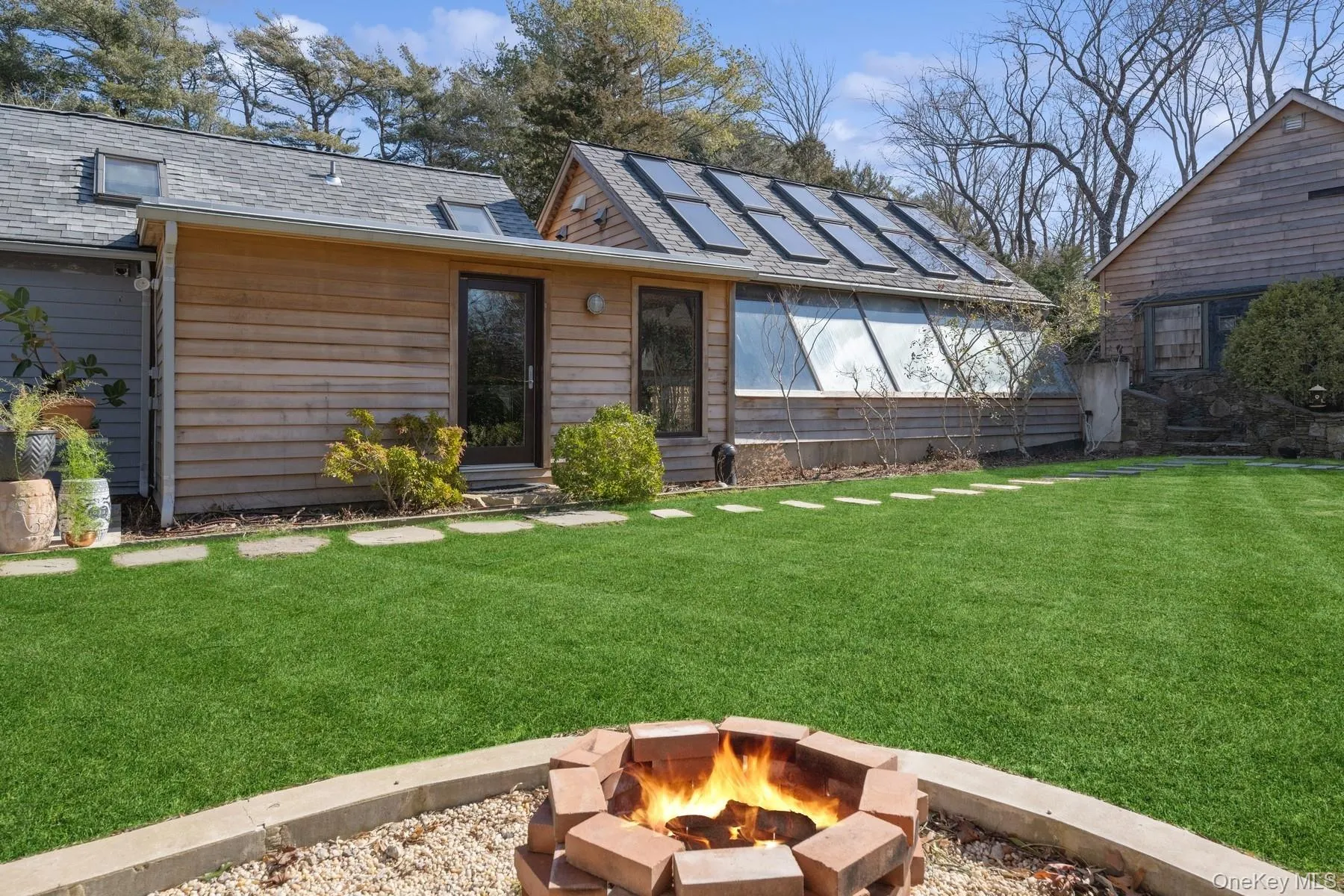 View of front of house with a front yard and a fire pit View of front of house with a front yard and a fire pit