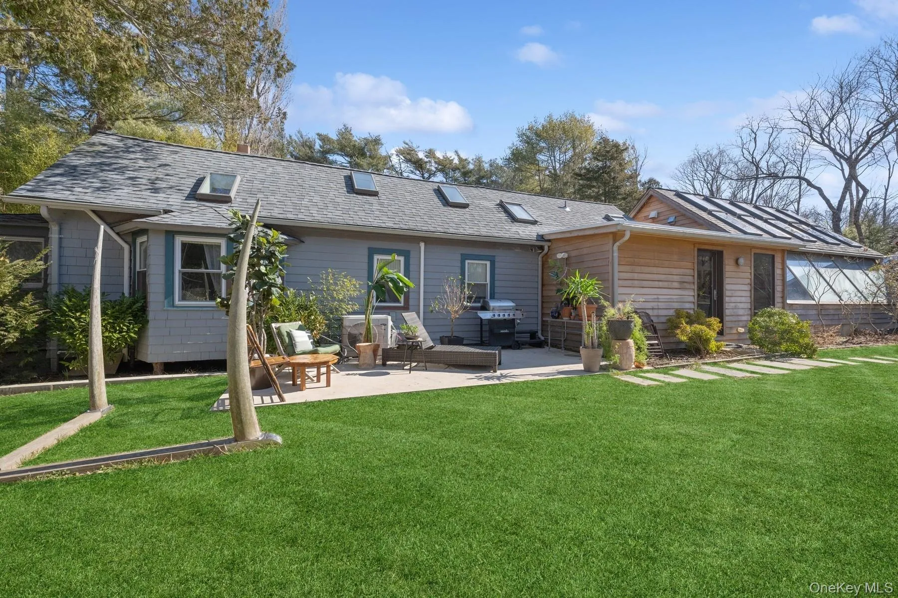 Rear view of property with a patio area and a yard Rear view of property with a patio area and a yard
