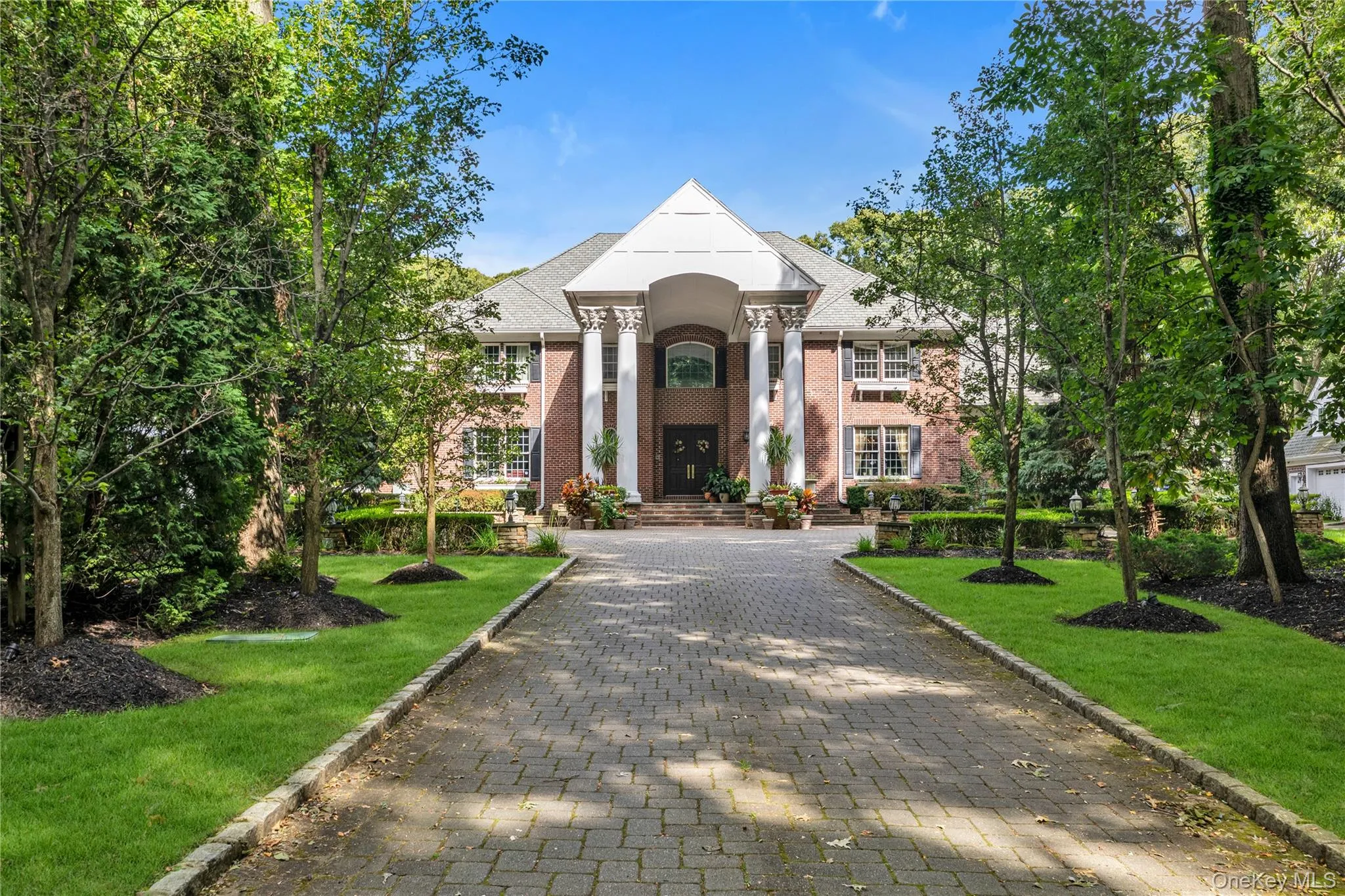 Enter through a long paver driveway Enter through a long paver driveway