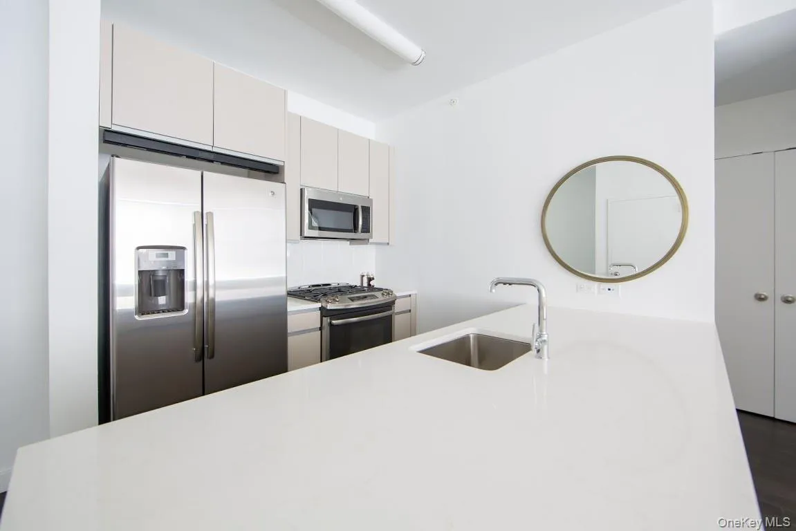 Kitchen featuring stainless steel appliances and light countertops Kitchen featuring stainless steel appliances and light countertops