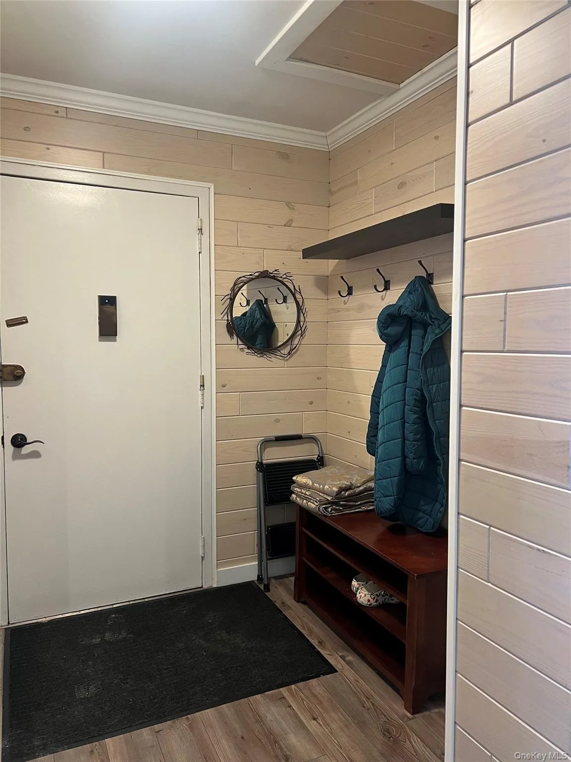 Entryway with coat hooks, storage and ceramic tile floor Entryway with coat hooks, storage and ceramic tile floor