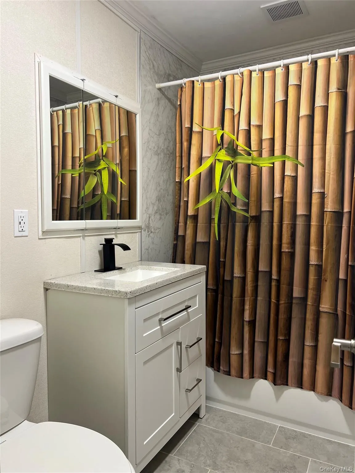 Renovated bathroom with new vanity, countertop, and ceramic tile floor Renovated bathroom with new vanity, countertop, and ceramic tile floor