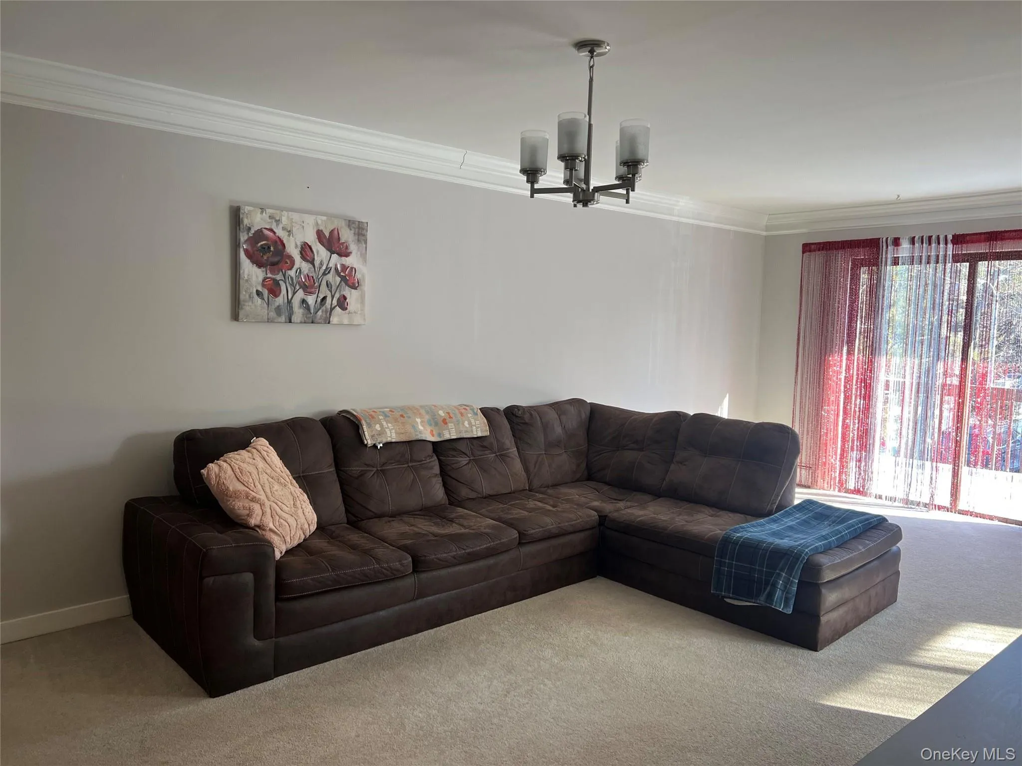 Living room with sliders to deck and carpeting Living room with sliders to deck and carpeting