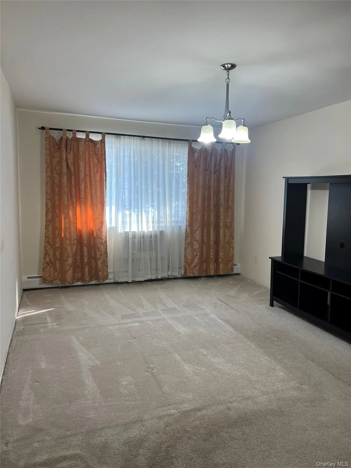 Bedroom with picture window and carpeting Bedroom with picture window and carpeting