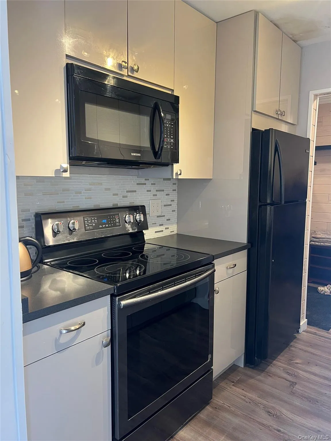 Renovated Kitchen with new appliances, countertops, cabinets, backsplash and ceramic tile floor Renovated Kitchen with new appliances, countertops, cabinets, backsplash and ceramic tile floor