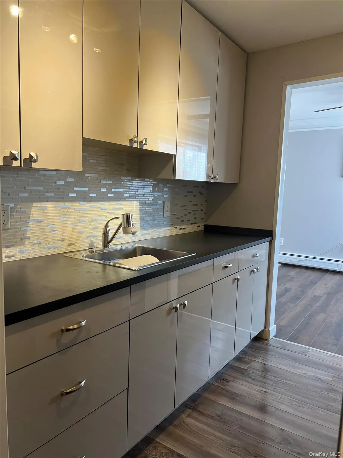 Renovated Kitchen with new countertops, cabinets, sink, backsplash and ceramic tile floor Renovated Kitchen with new countertops, cabinets, sink, backsplash and ceramic tile floor