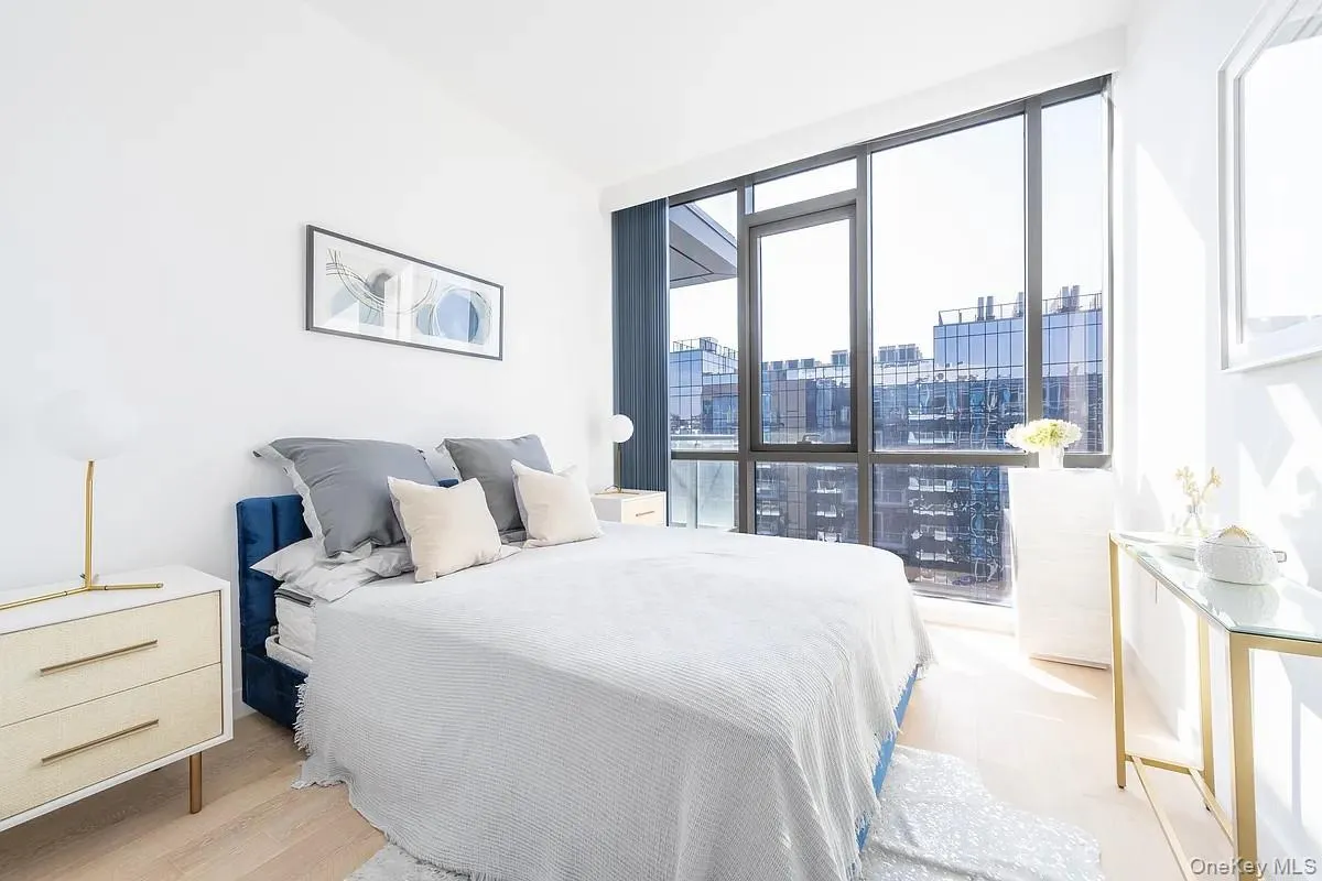 Bedroom with a city view and light wood finished floors Bedroom with a city view and light wood finished floors