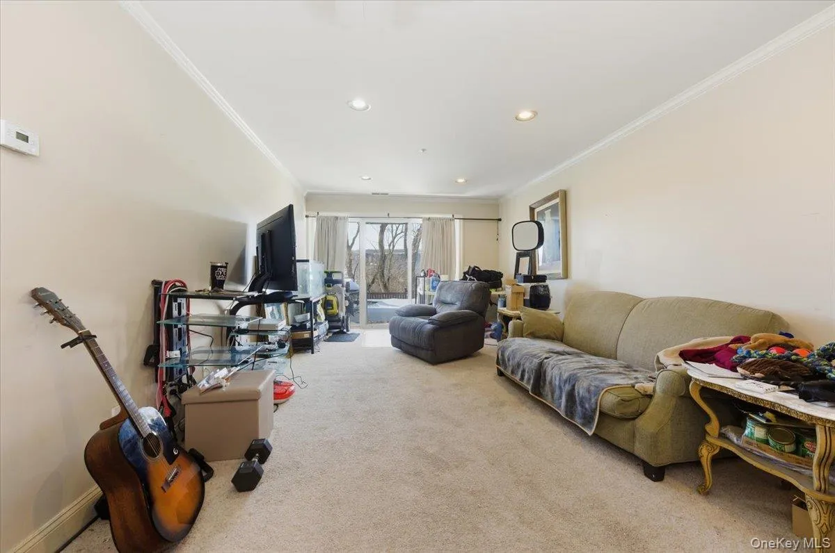 Lower level recreation area featuring carpet floors, ornamental molding, and recessed lighting Lower level recreation area featuring carpet floors, ornamental molding, and recessed lighting