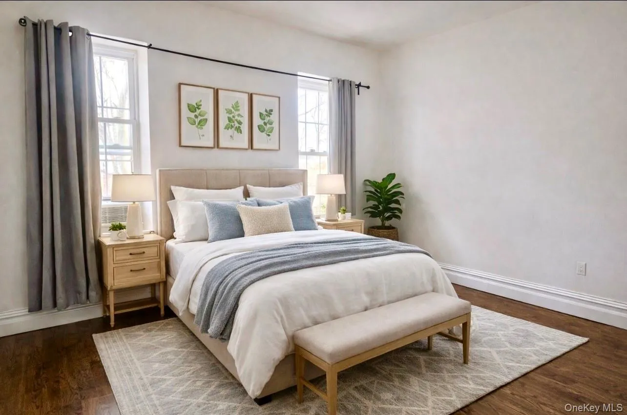 Bright, spacious, and peaceful, the primary bedroom comfortably fits a queen or king-size bed with room to spare for dressers or nightstands. Two large windows bring in beautiful natural light throughout the day, creating an open and airy feel. Hardwood floors and clean finishes make this a relaxing retreat to unwind after a long day. Bright, spacious, and peaceful, the primary bedroom comfortably fits a queen or king-size bed with room to spare for dressers or nightstands. Two large windows bring in beautiful natural light throughout the day, creating an open and airy feel. Hardwood floors and clean finishes make this a relaxing retreat to unwind after a long day.