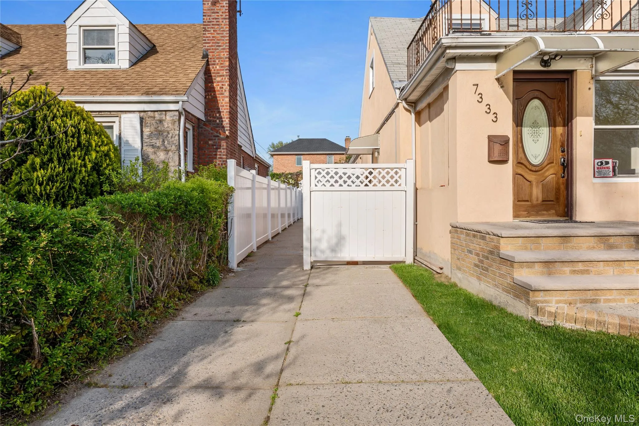 View of home's exterior with fence, a chimney, a shingled roof, and a balcony View of home's exterior with fence, a chimney, a shingled roof, and a balcony