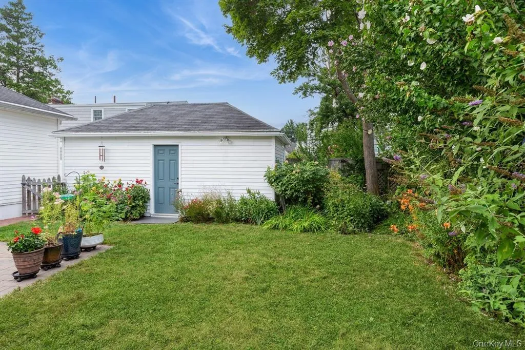 Side Entrance to Garage in Well-Manicured Yard Side Entrance to Garage in Well-Manicured Yard