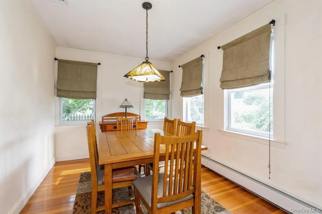 Formal Dining Room with Hardwood Floors and Ample Natural Light Formal Dining Room with Hardwood Floors and Ample Natural Light