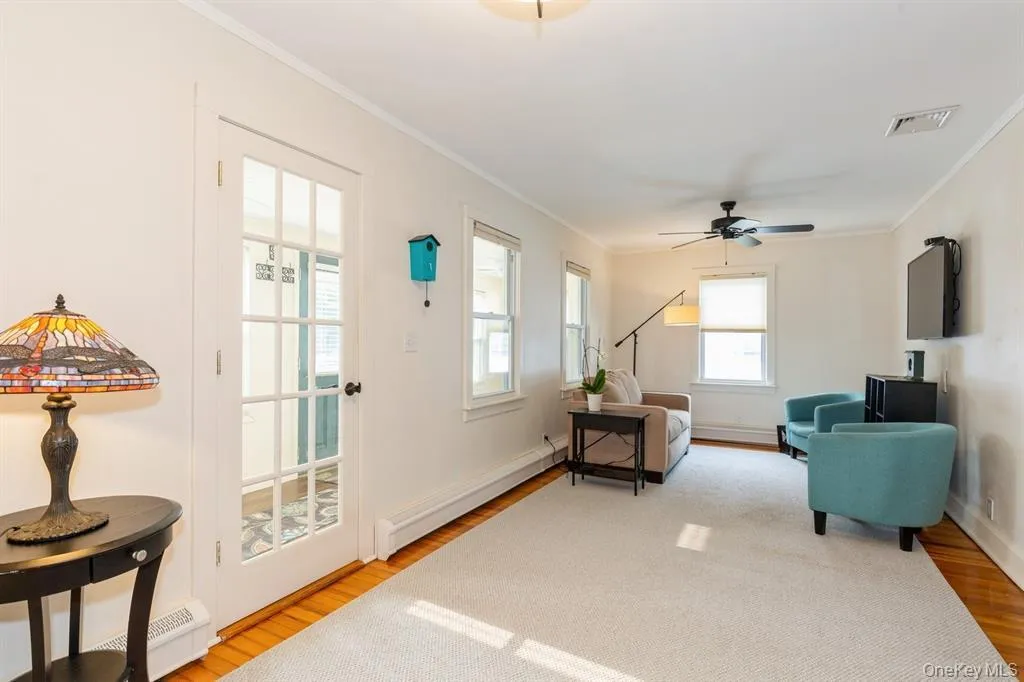 Living area with crown molding, and a ceiling fan Living area with crown molding, and a ceiling fan