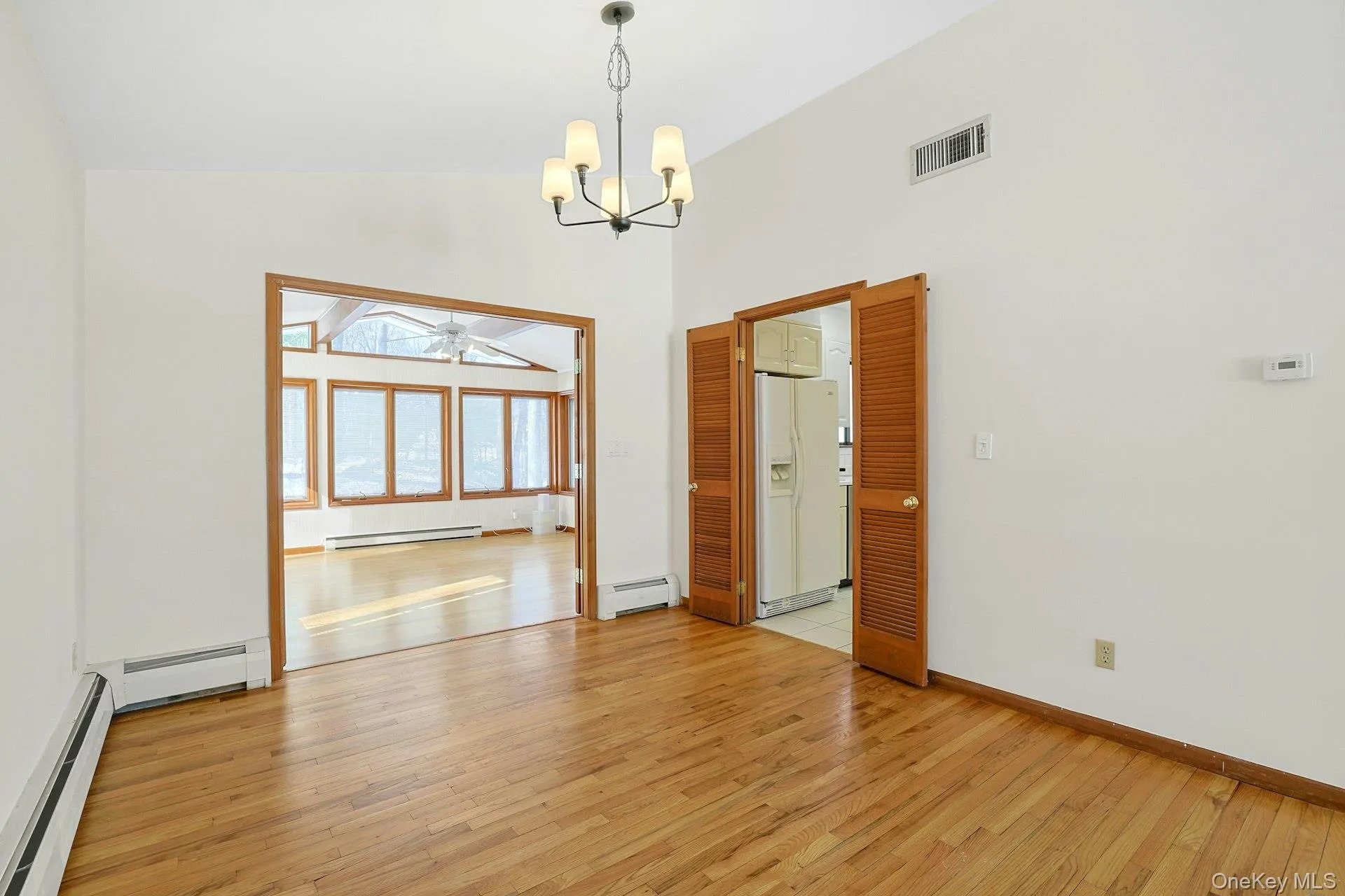 The dining room is centered under a modern chandelier. The doors to the family room can close for peace and quiet. The dining room is centered under a modern chandelier. The doors to the family room can close for peace and quiet.
