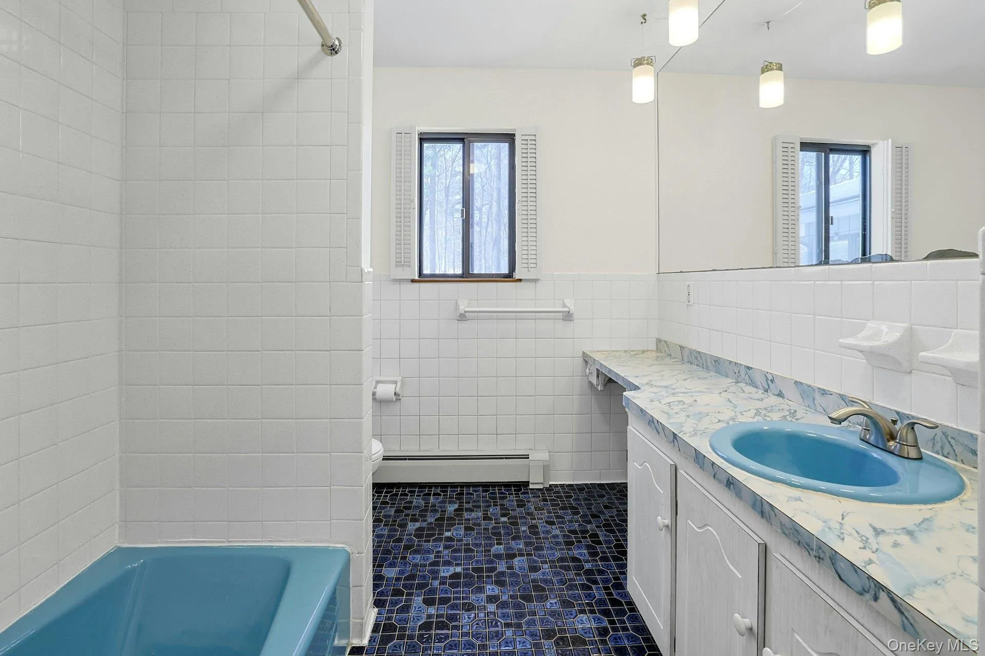 The full hall bathroom, with a tub/shower, large vanity and linen closet. The full hall bathroom, with a tub/shower, large vanity and linen closet.