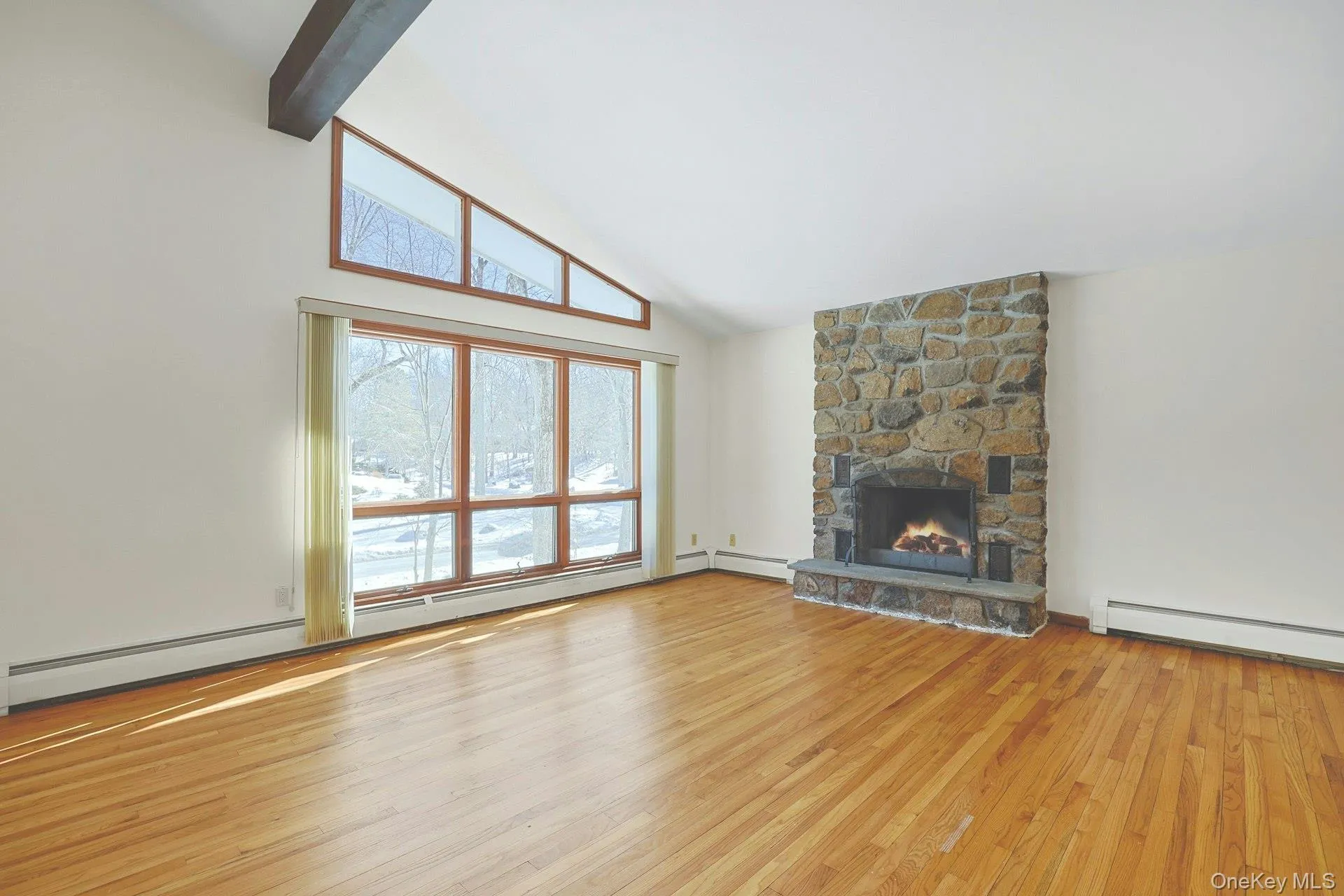 The expansive living room is centered around the stone, wood-burning fireplace. The expansive living room is centered around the stone, wood-burning fireplace.
