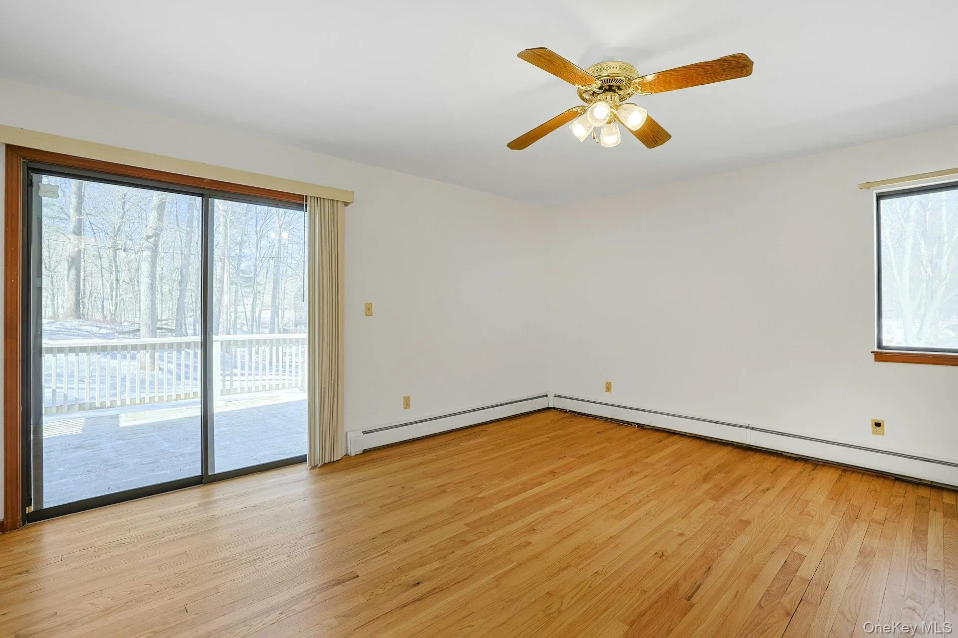 The expansive primary bedroom has sliding doors to the rear deck. The expansive primary bedroom has sliding doors to the rear deck.