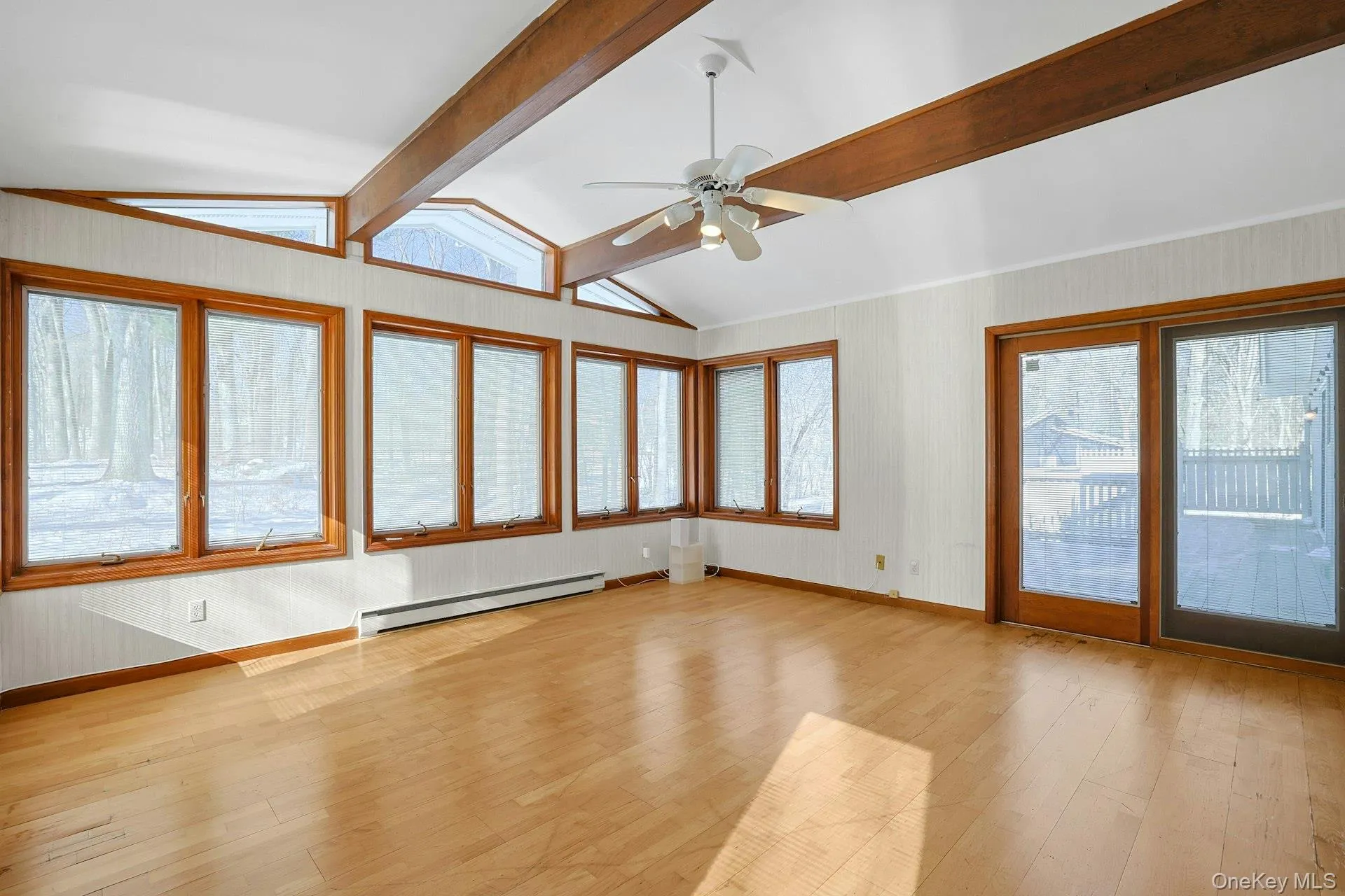 Sliding glass doors open to the rear deck, which runs nearly the length of the home. Sliding glass doors open to the rear deck, which runs nearly the length of the home.