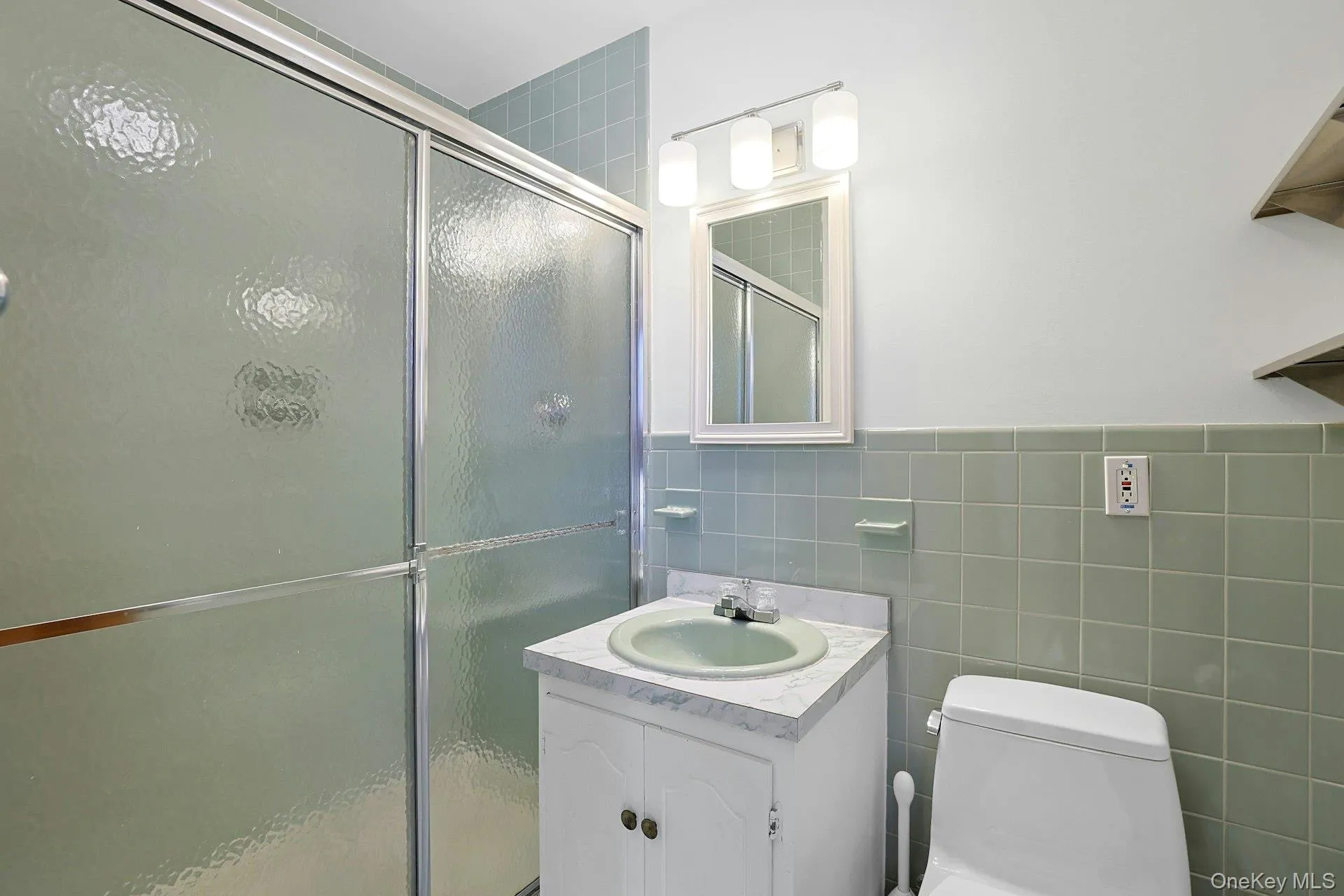 The primary bathroom features a large glass shower and tile surround. The primary bathroom features a large glass shower and tile surround.