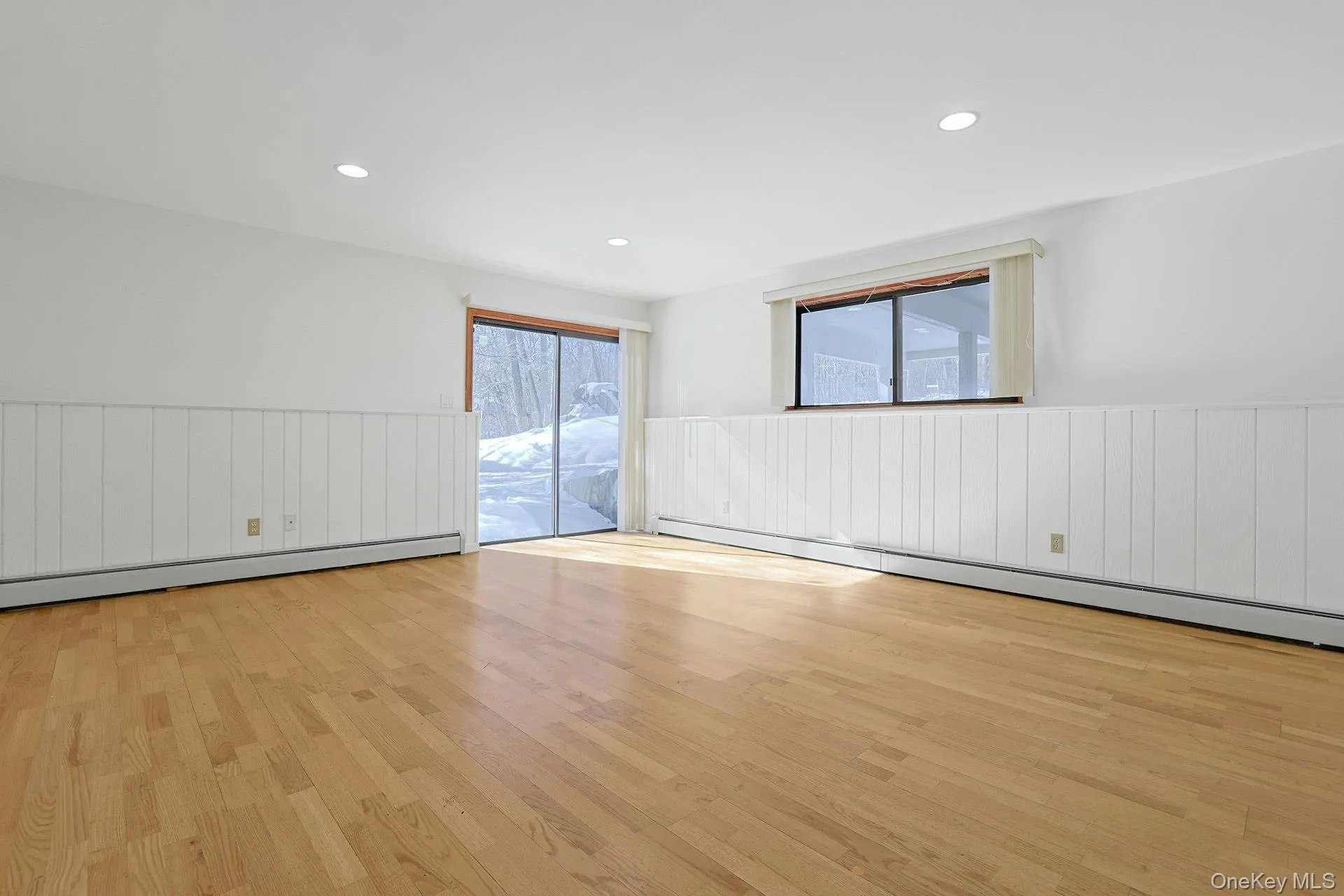 On the lower level, the den has sliding doors out to the side yard. This space could also be used as the fourth bedroom, if desired. On the lower level, the den has sliding doors out to the side yard. This space could also be used as the fourth bedroom, if desired.