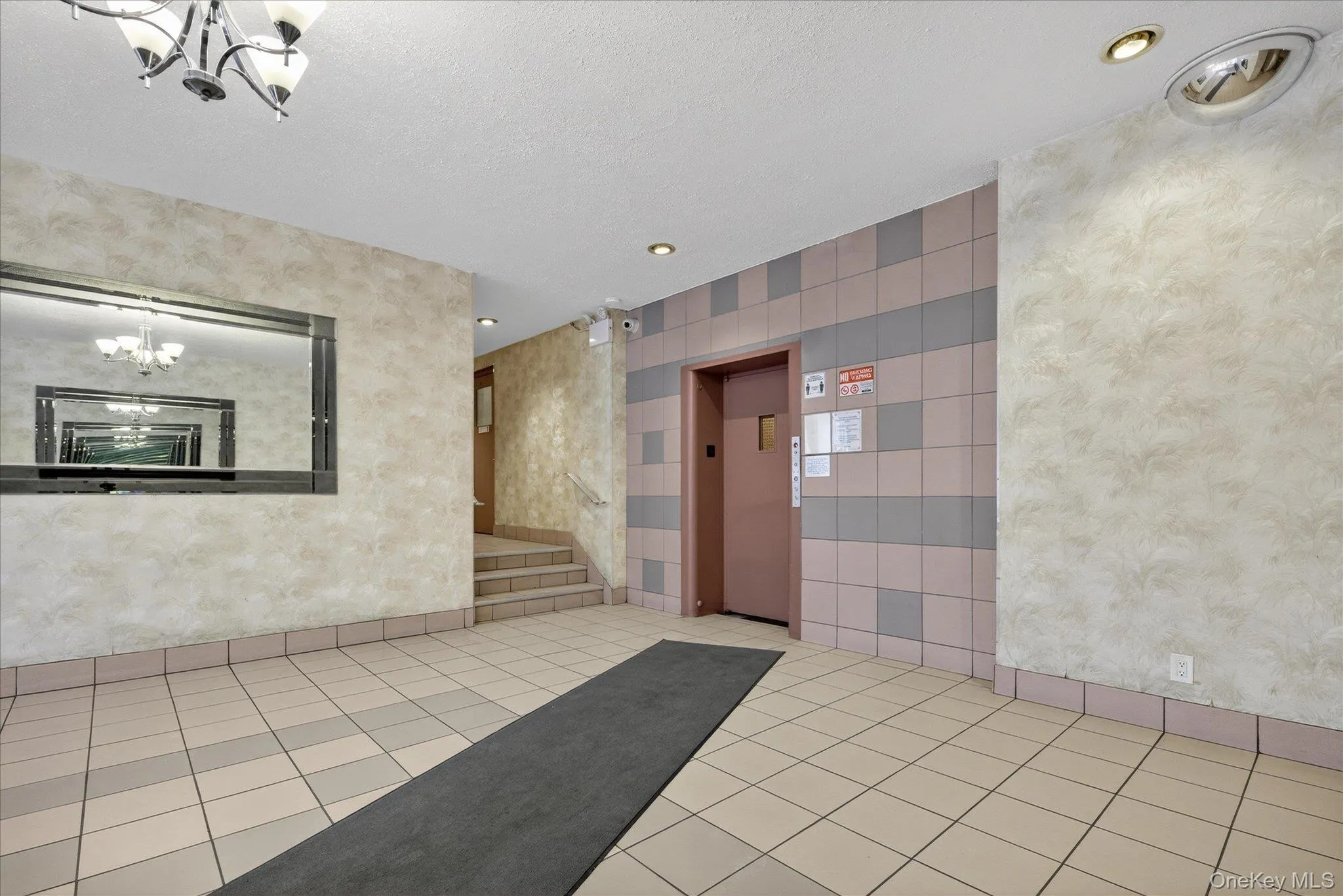 Lobby with wallpapered walls and a textured ceiling Lobby with wallpapered walls and a textured ceiling