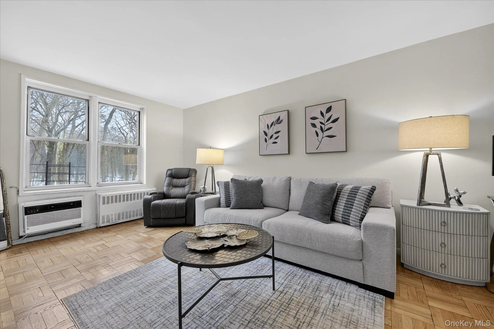 Living area with parquet floors and radiator heating unit Living area with parquet floors and radiator heating unit