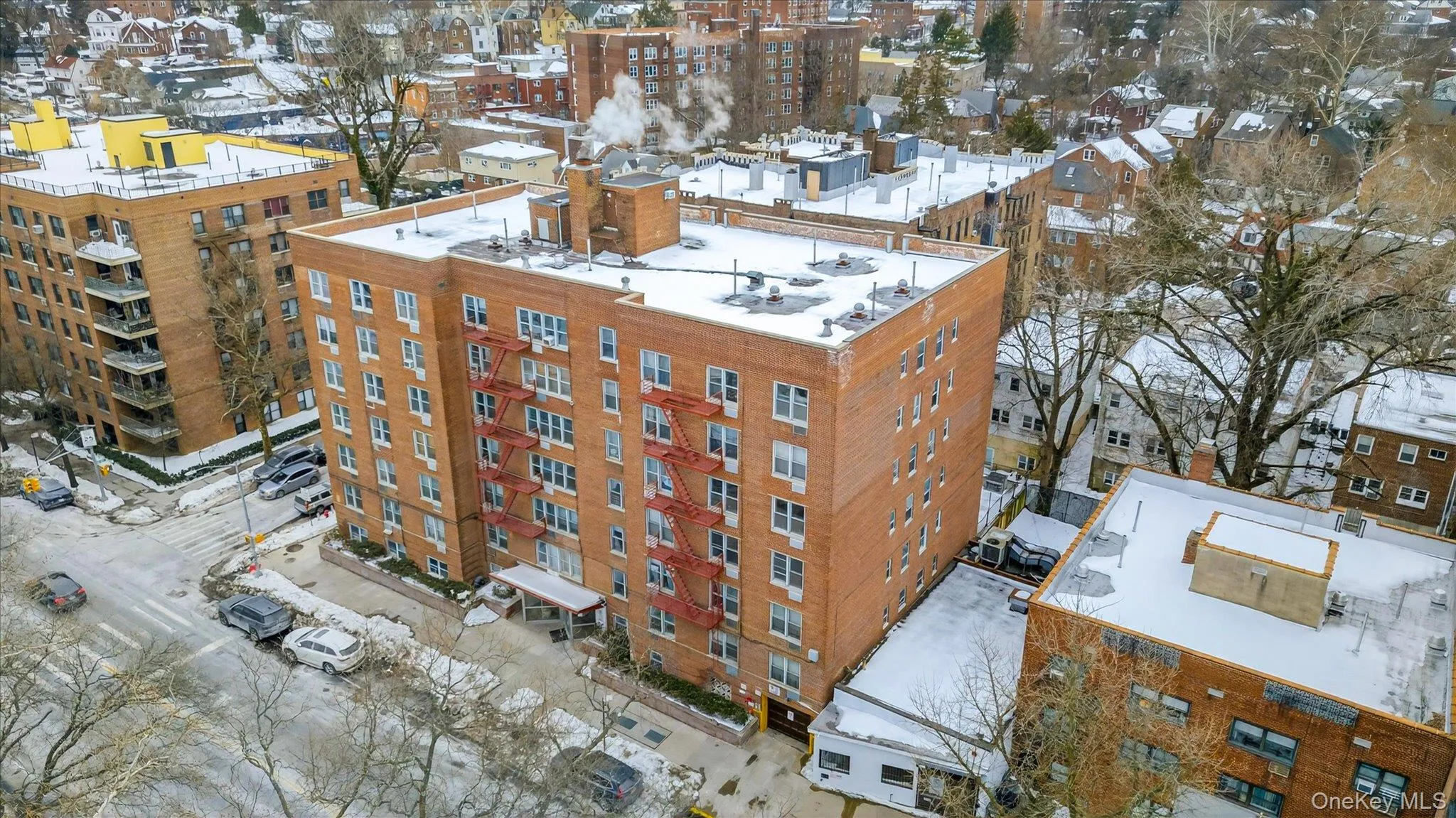 Snowy aerial view with a view of apartment building / complex Snowy aerial view with a view of apartment building / complex